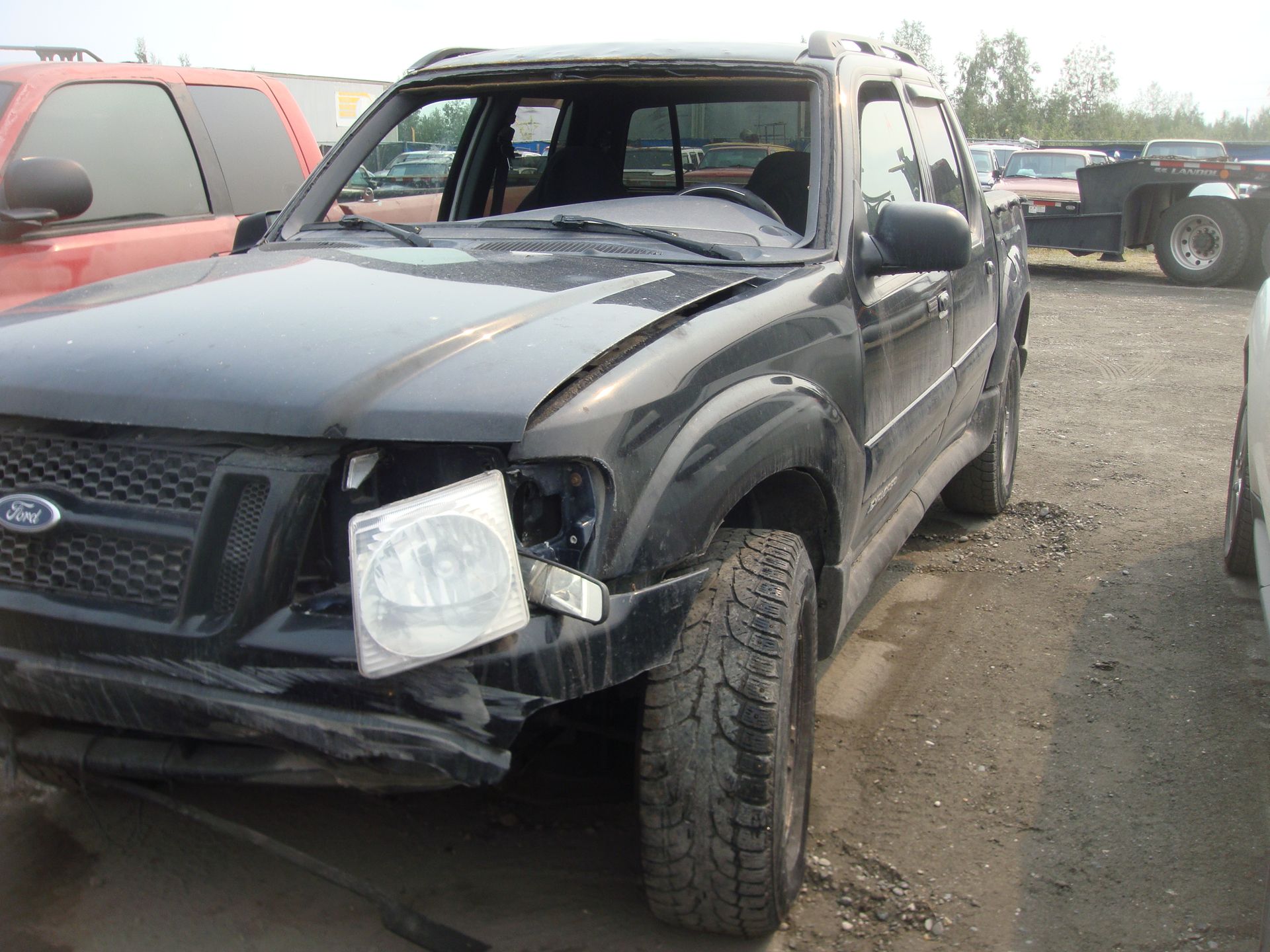 A black ford explorer is sitting in a parking lot