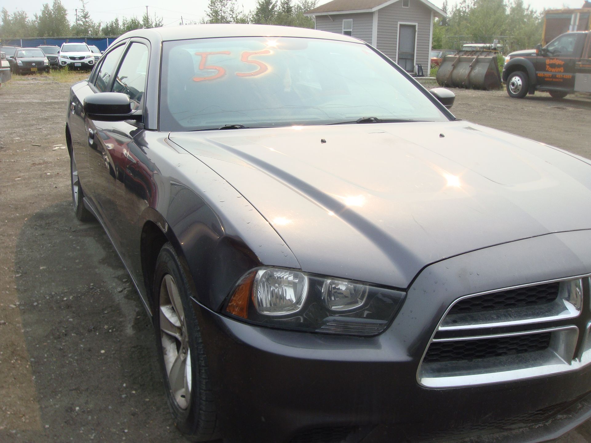 A gray dodge charger is parked in a parking lot