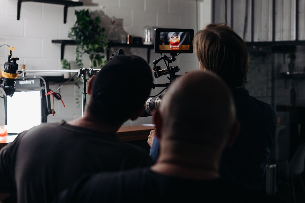 A group of people are watching a video on a camera.