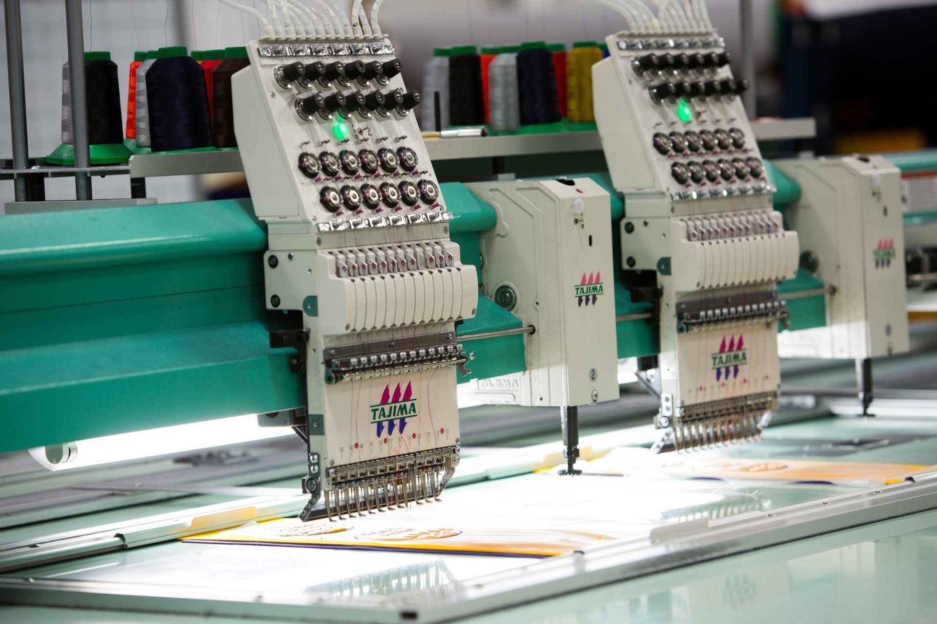 Custom chenille patches being sewed together on fabric.