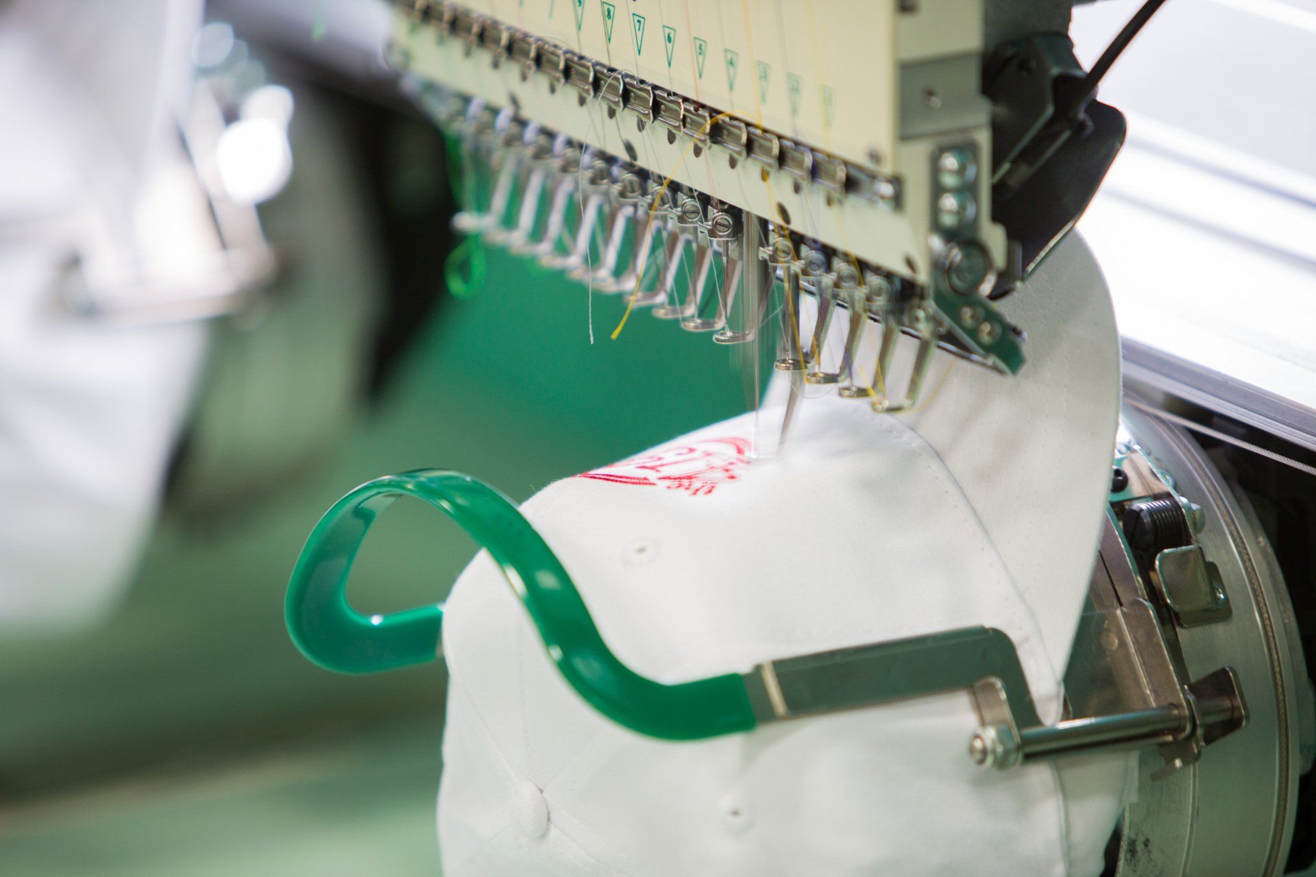 A logo being stitched into a hat.