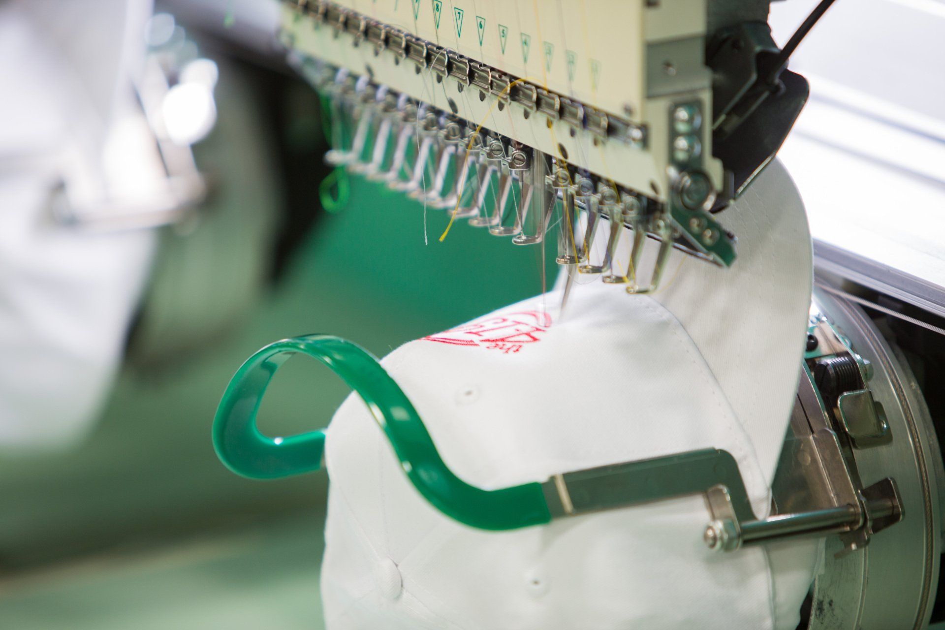 A logo being stitched into a hat.