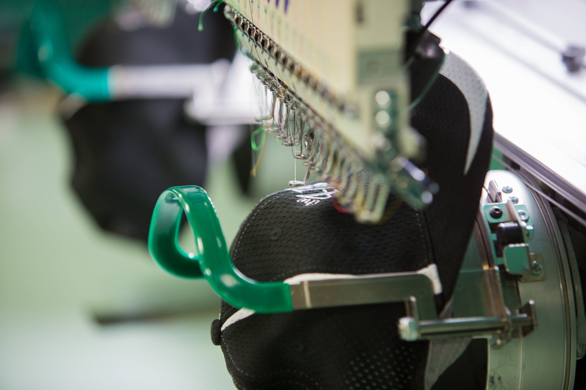 A logo being stitched into a hat.