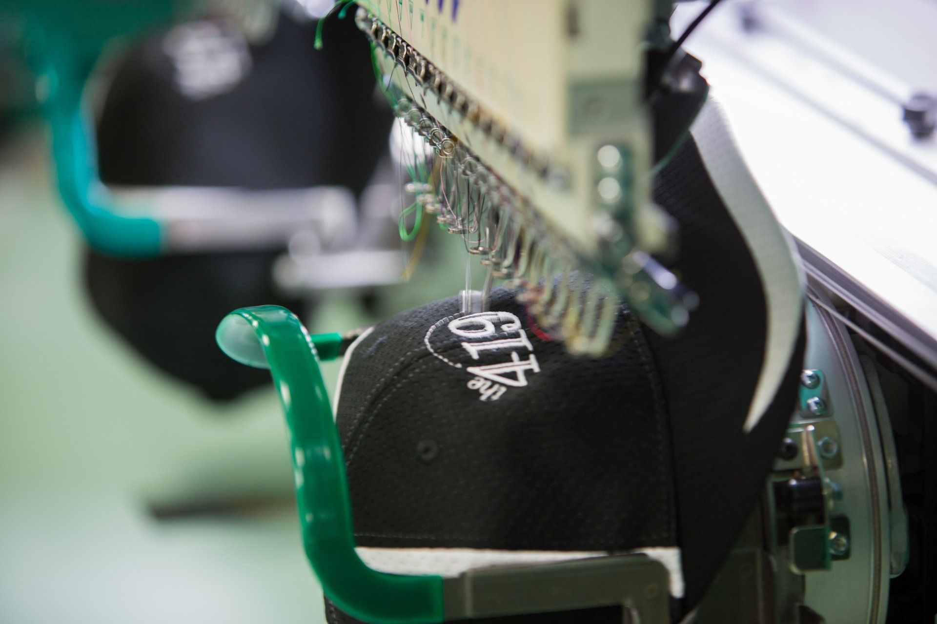 Numbers being stitched into multiple hats.