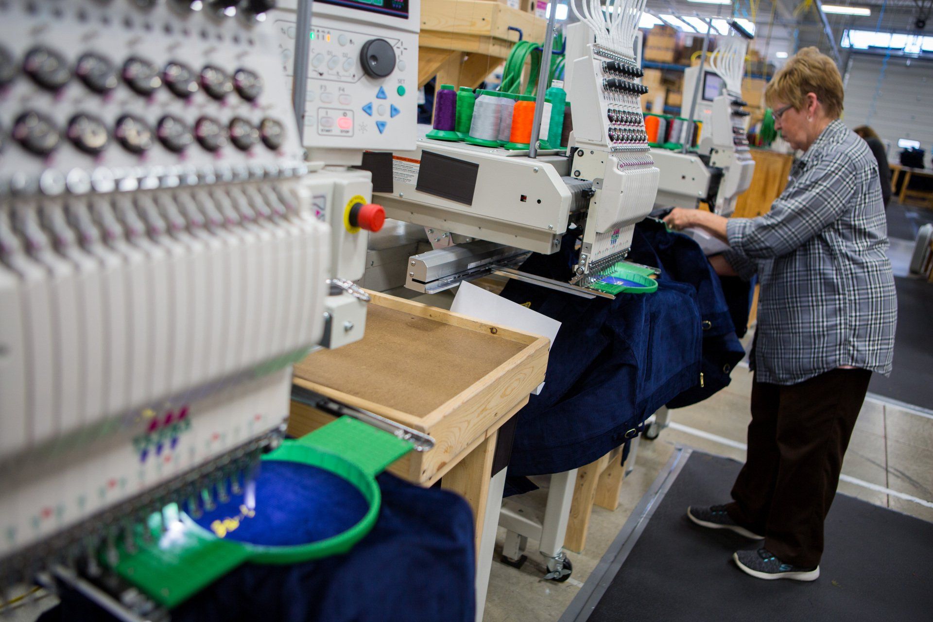 A name being stitched onto a jacket.