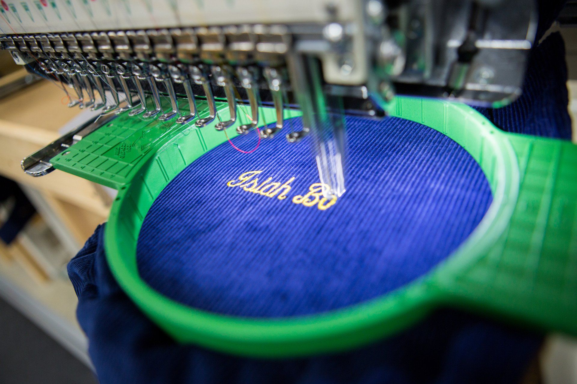 A name being stitched onto a jacket.