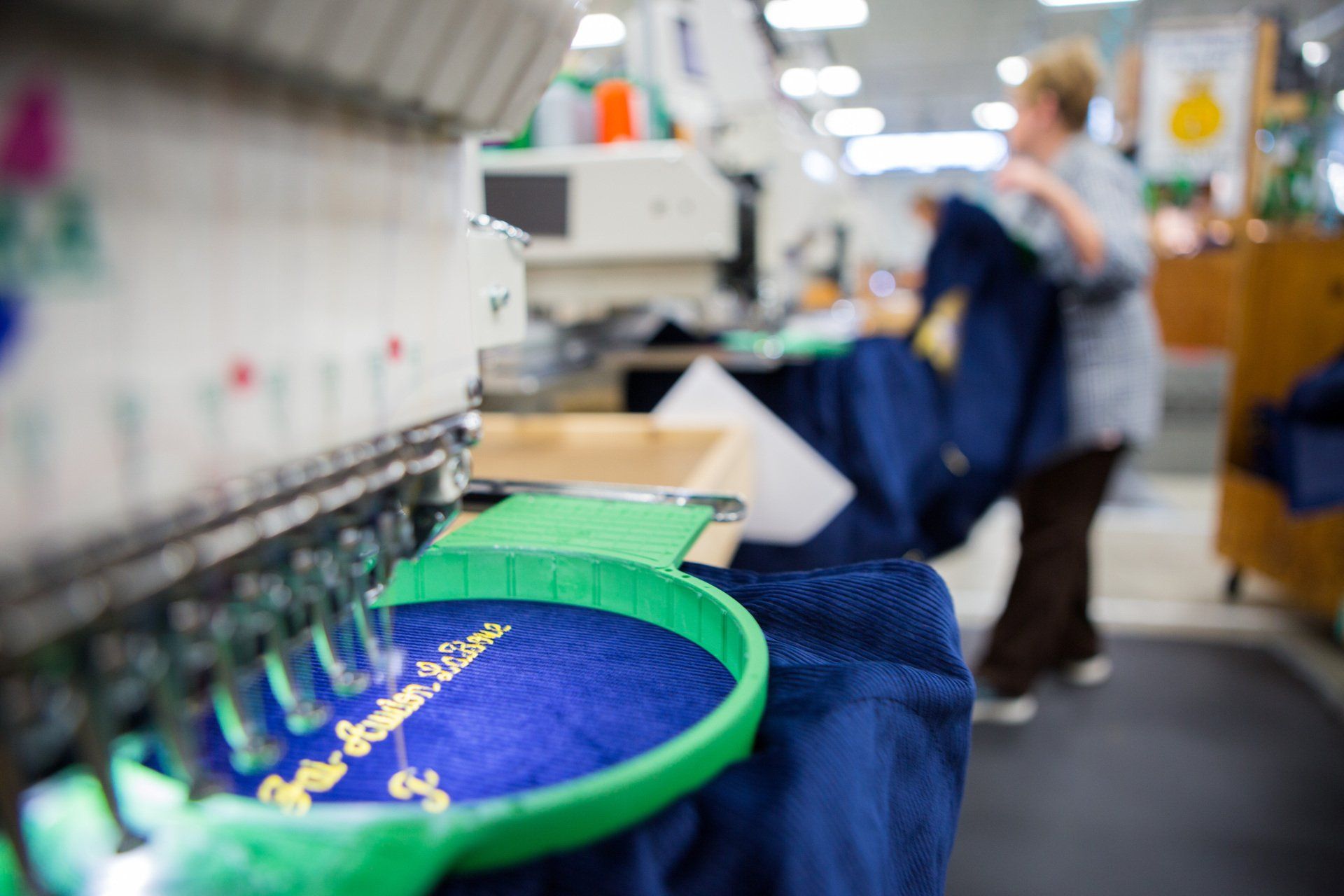 A name being stitched onto a jacket.