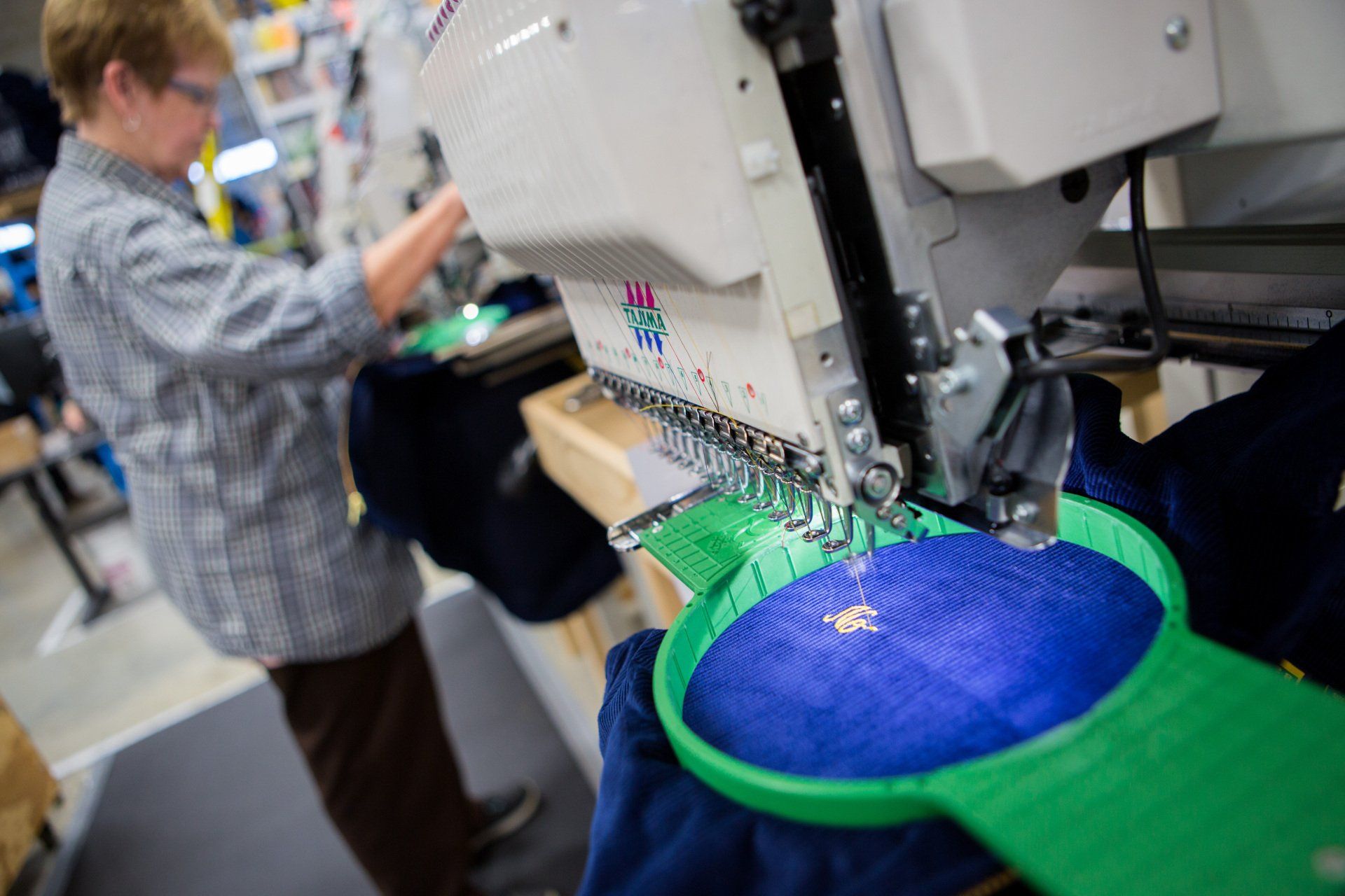 A name being stitched onto a jacket.