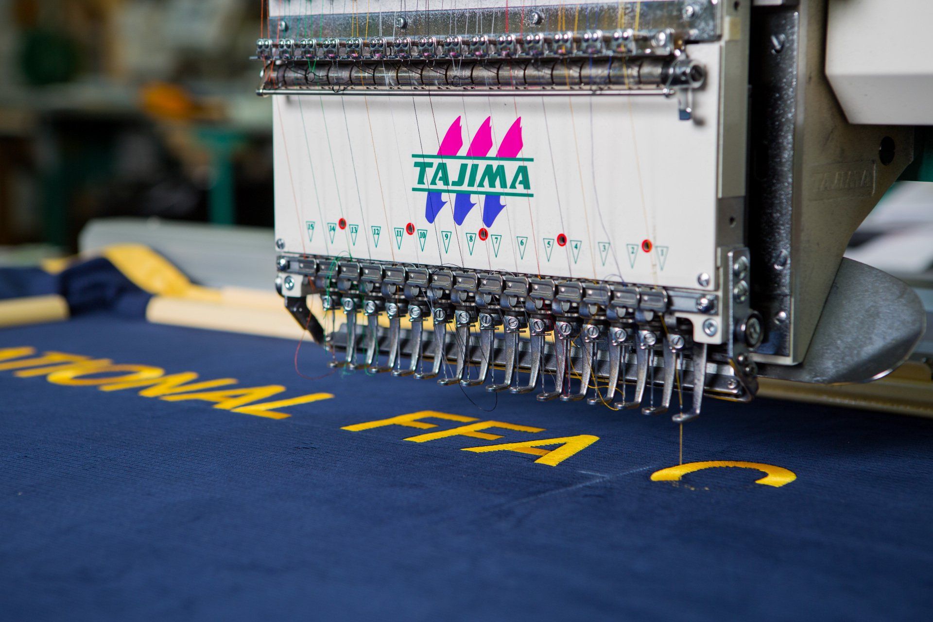 Words being stitched onto a FFA banner.