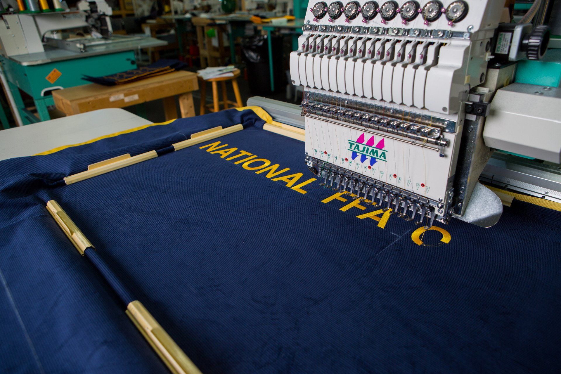 Words being stitched onto a FFA banner.