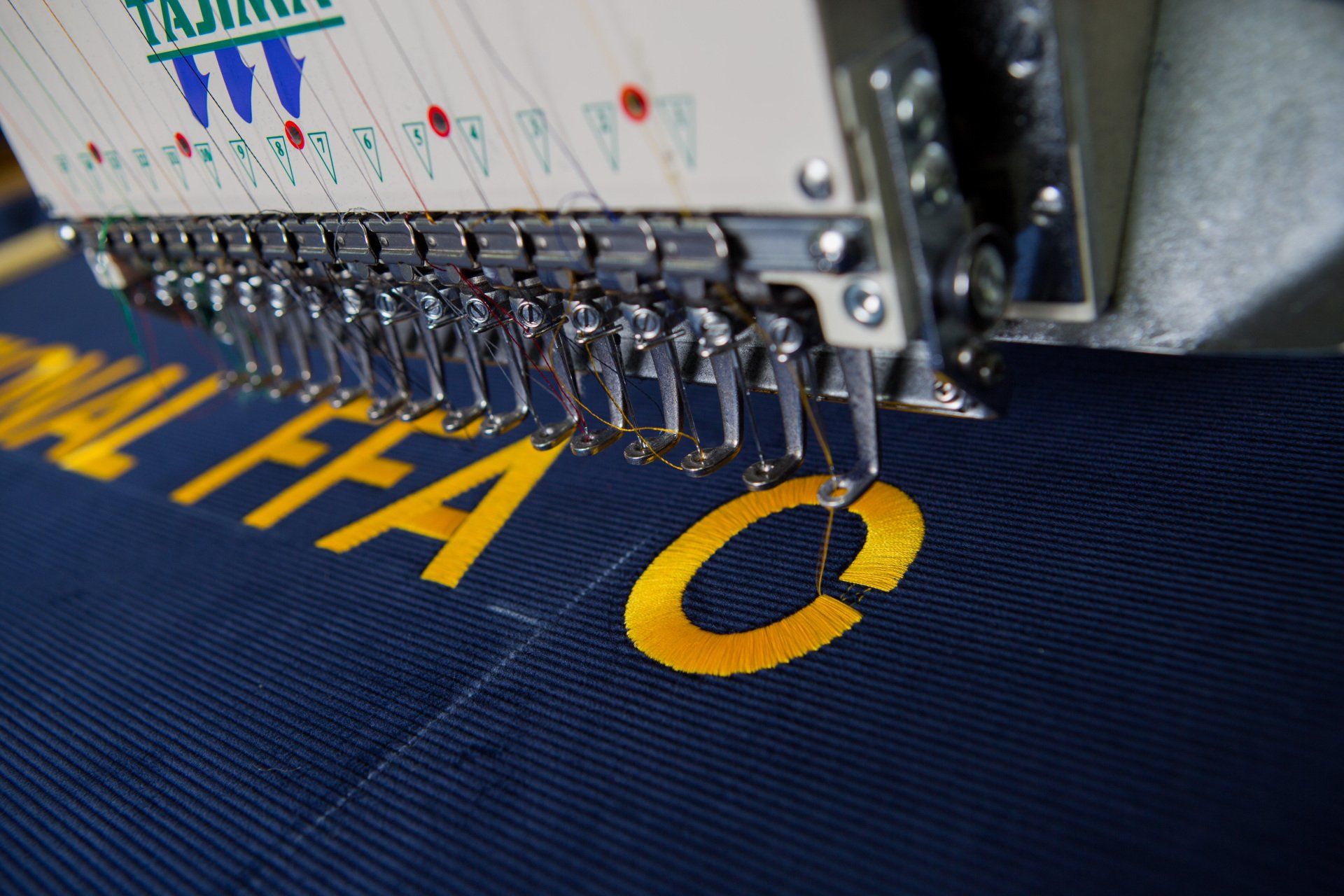 Words being stitched onto a FFA banner.