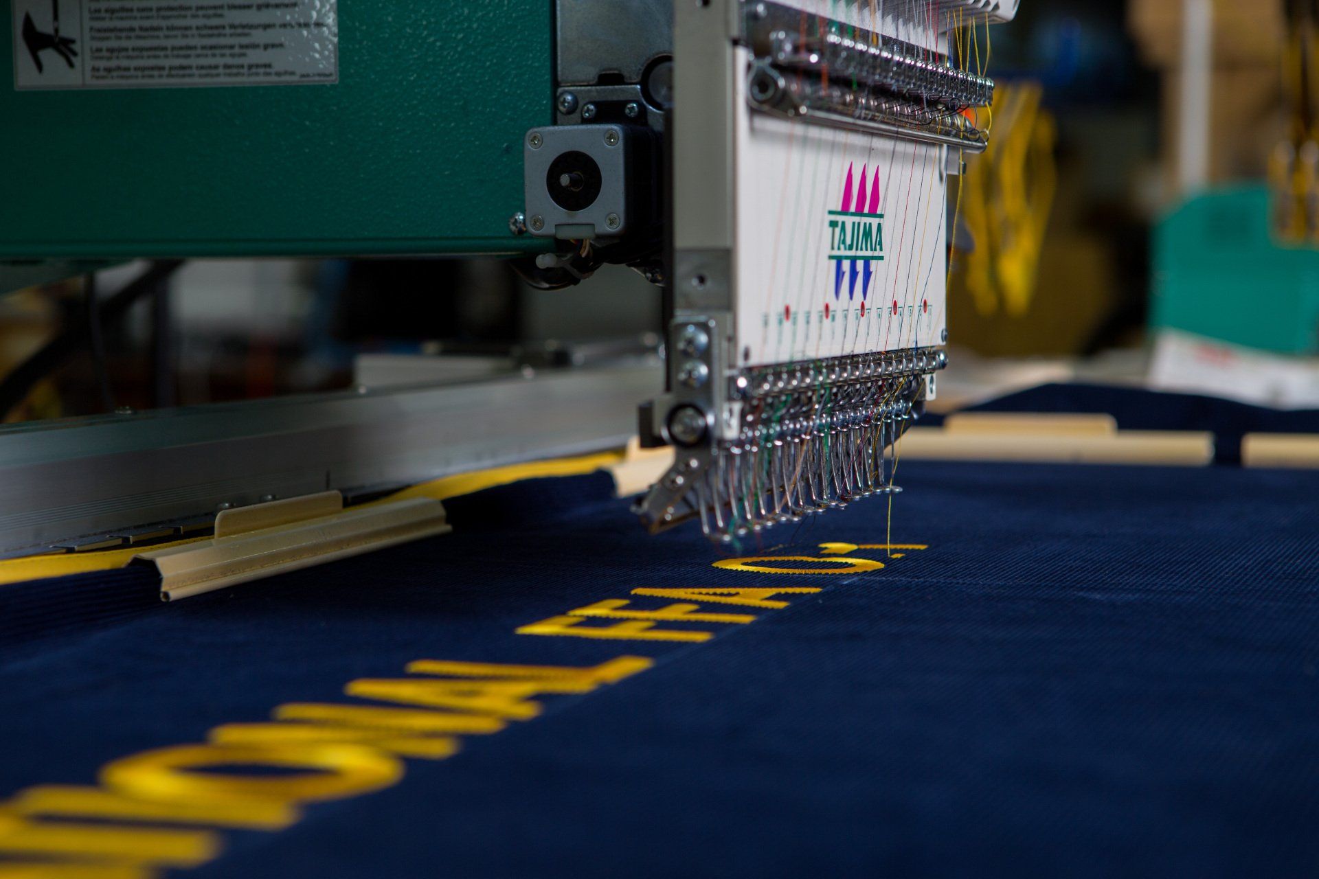 Nation FFA being sewed onto a banner.