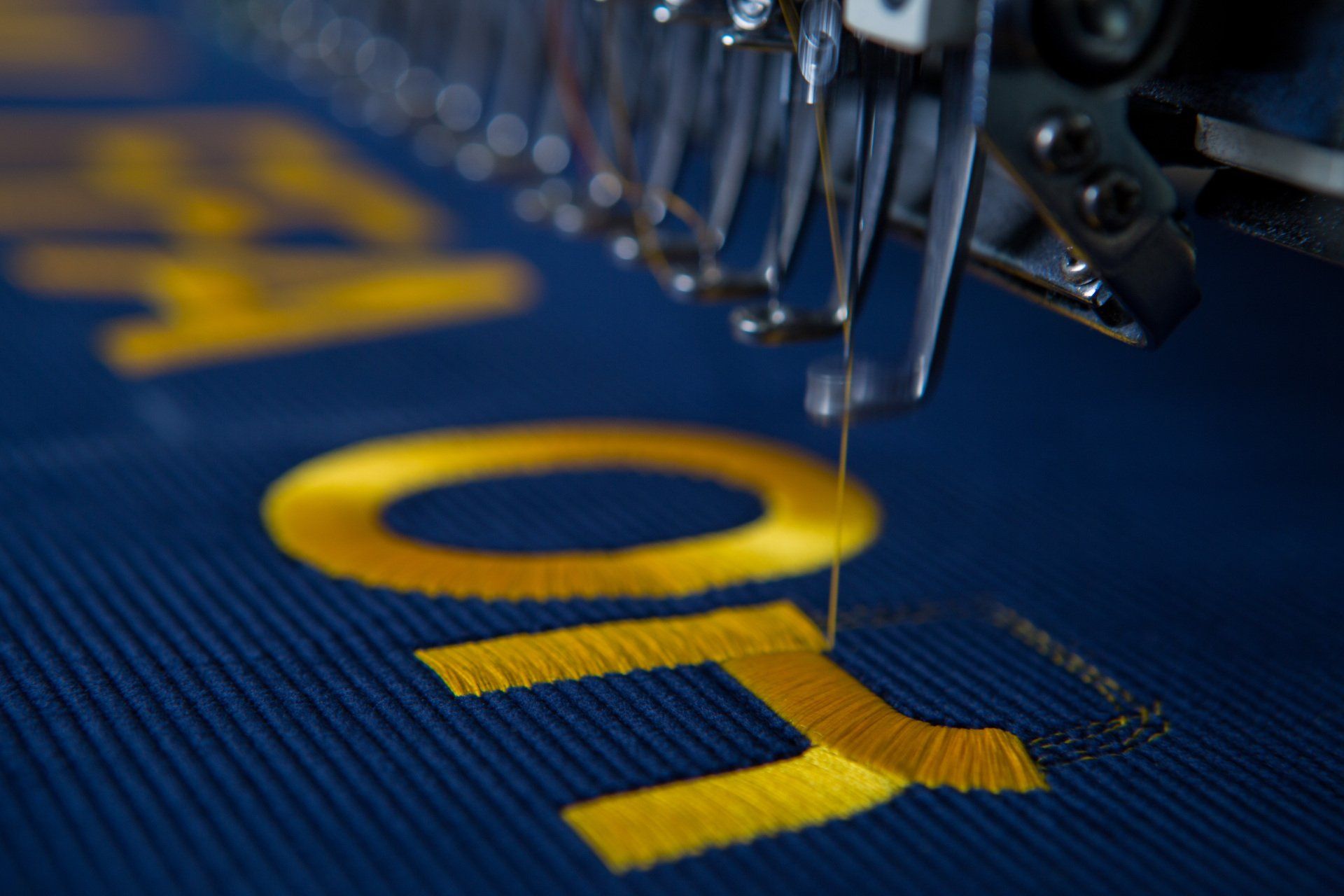 Words being stitched onto a FFA banner.