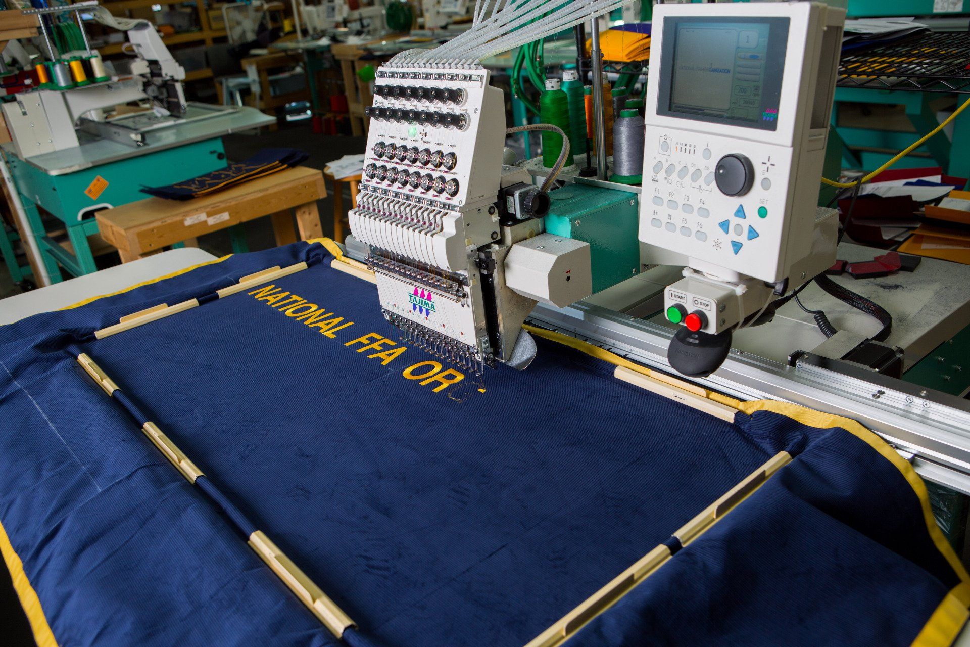 Nation FFA being sewed onto a banner.