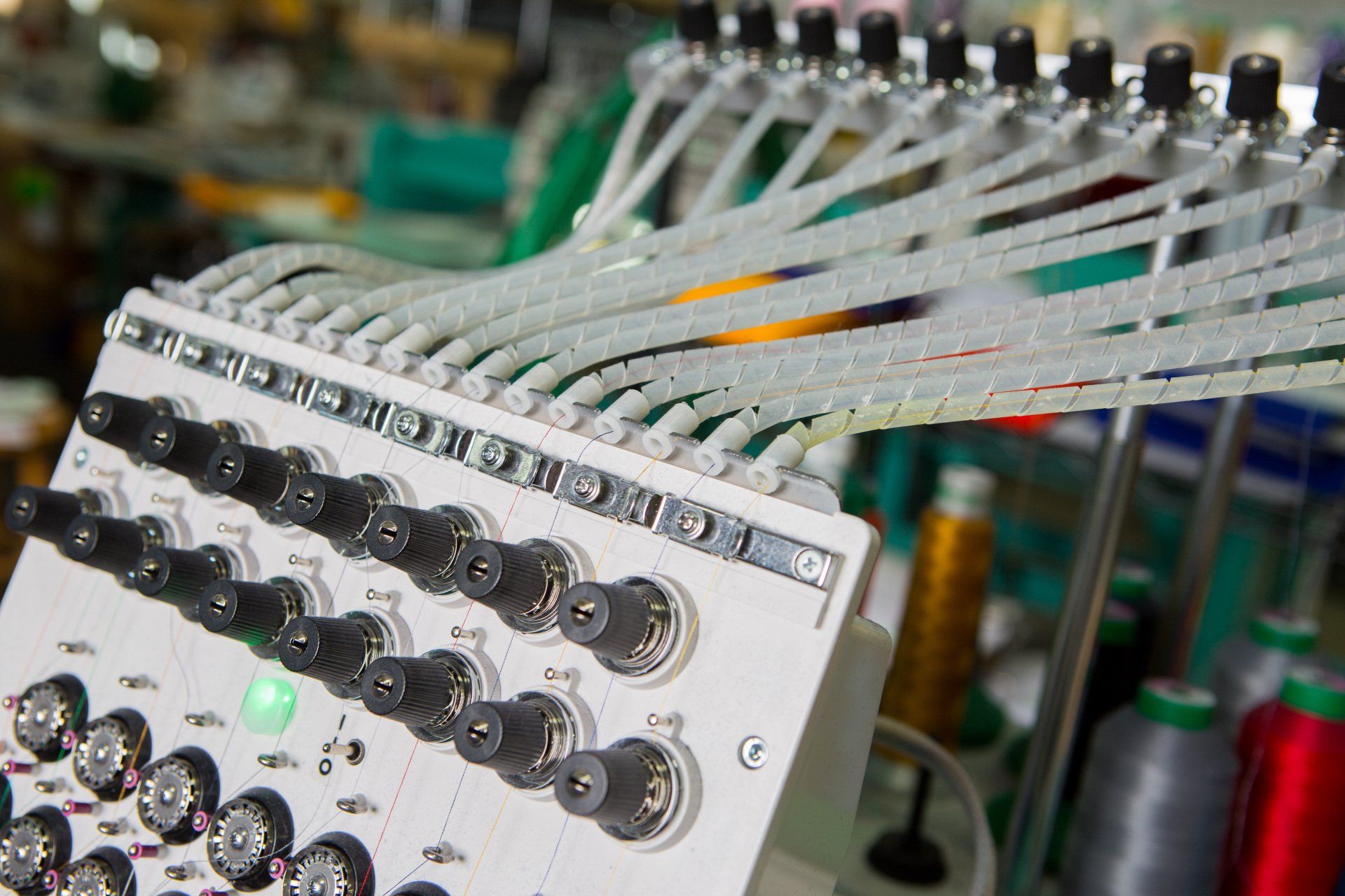 Wires leading fabric into a sewing machine.