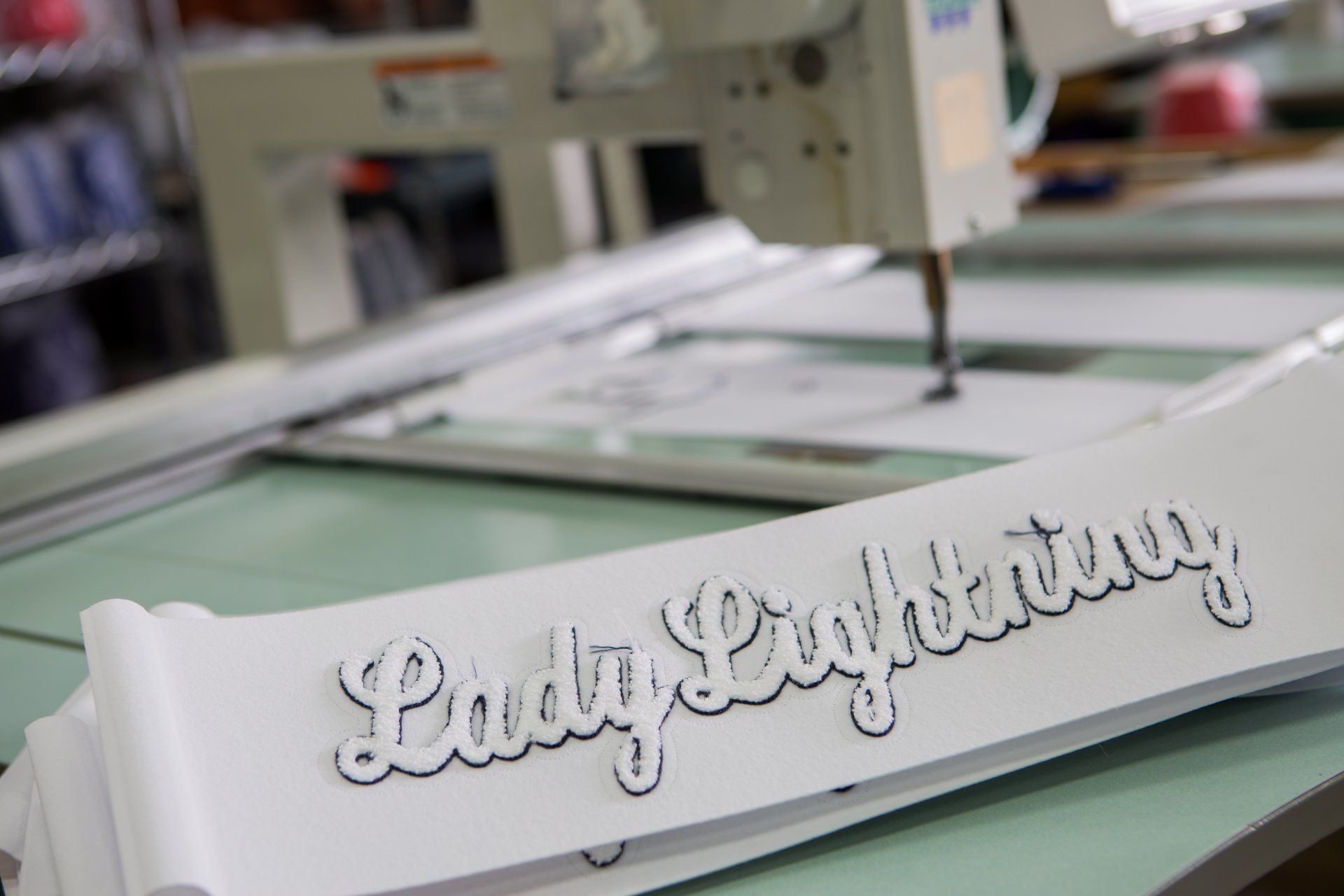 Lady Lightning sewed into white fabric.