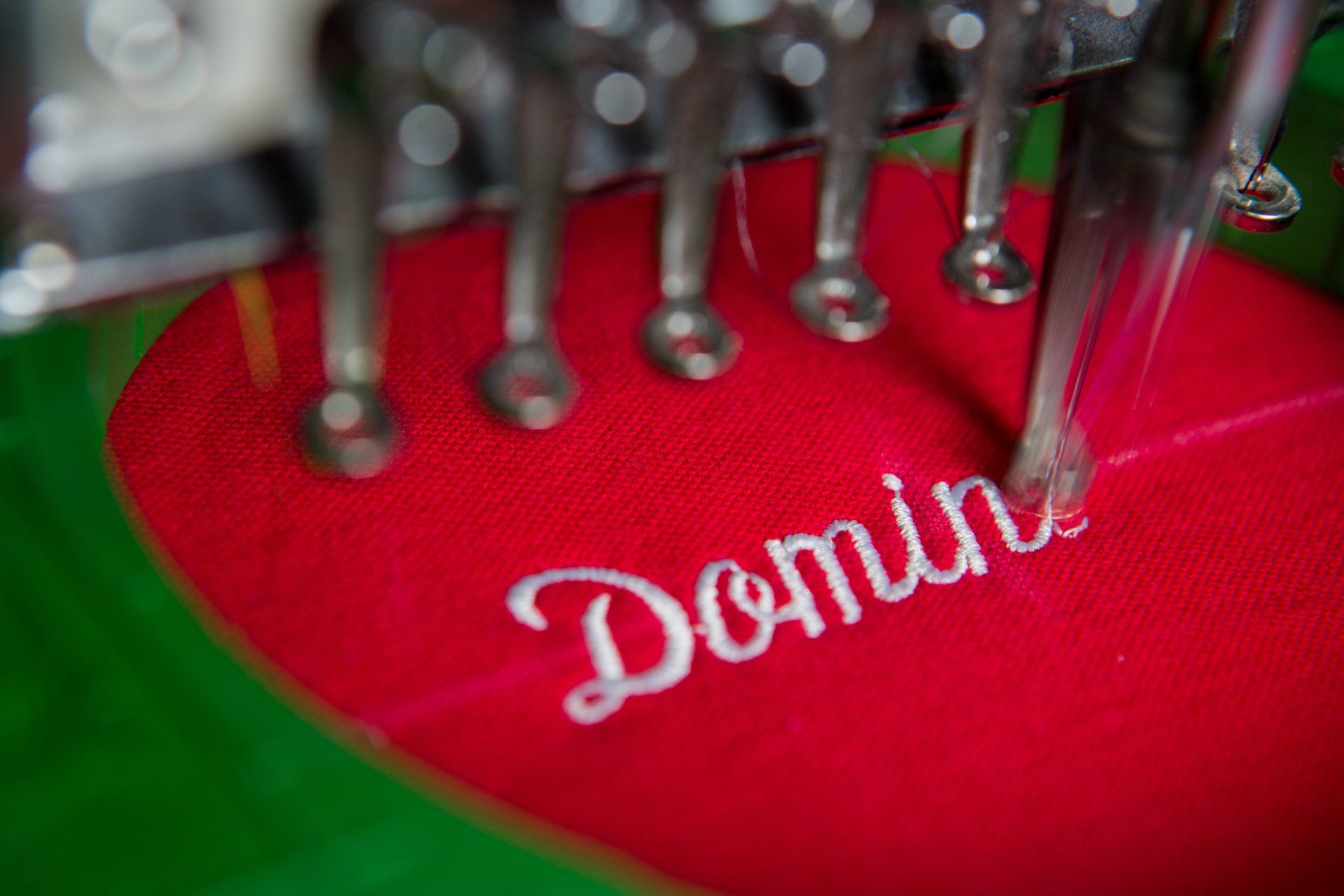 The letters Domin are being custom embroidered on.
