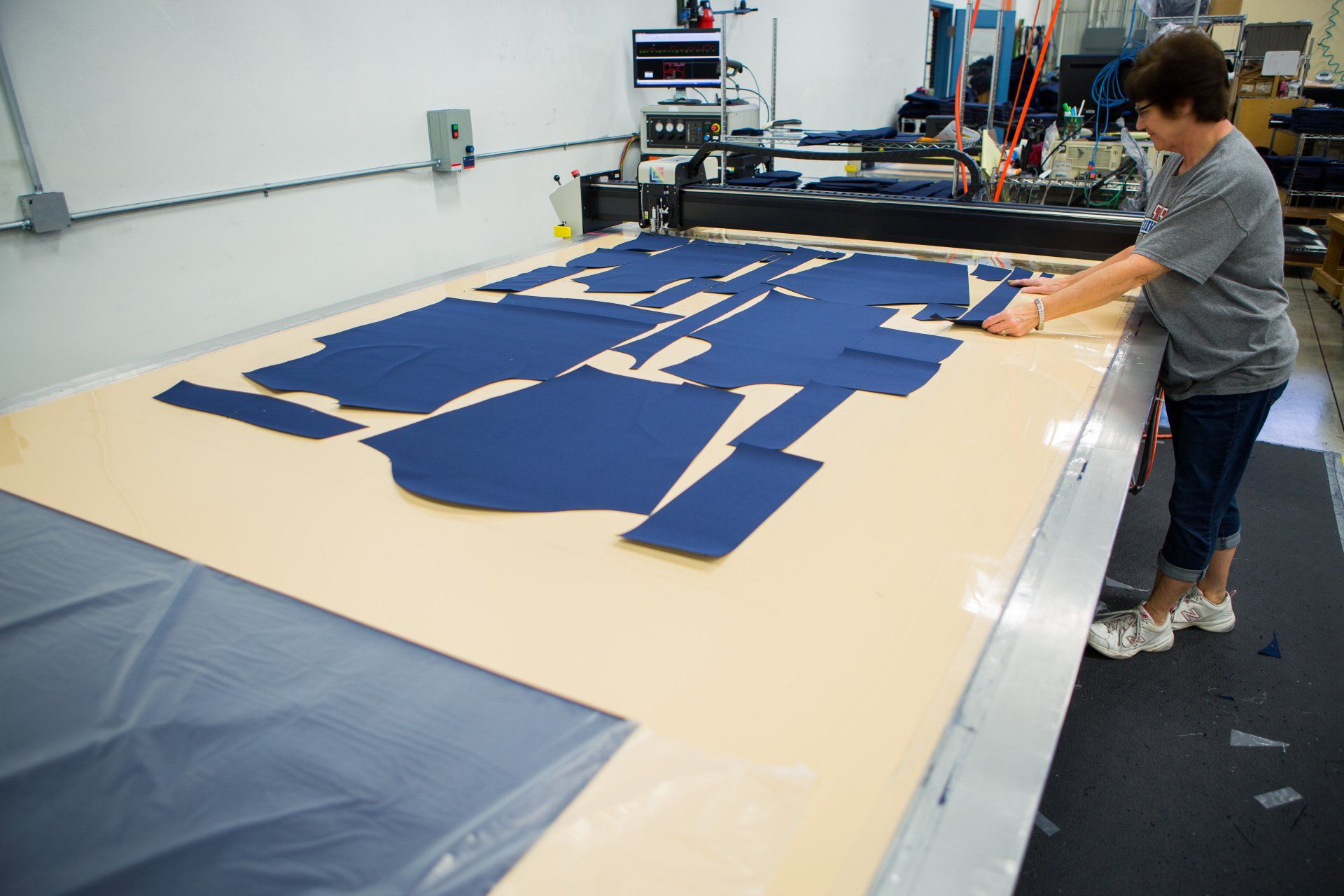 The fabric needed to make a FFA jacket all cut and layed out on a table.