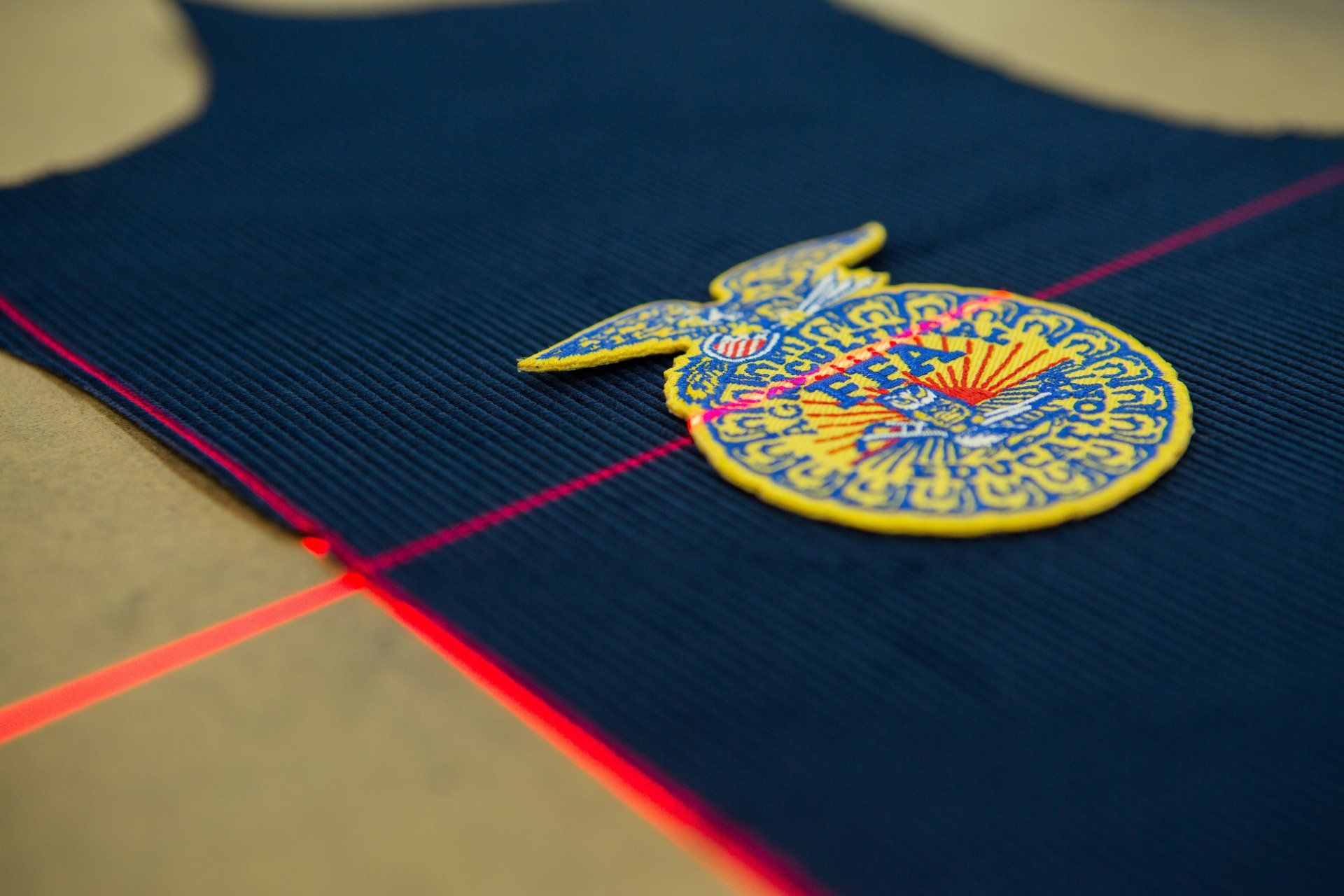 red lasers being used to measure out FFA jackets and patches.