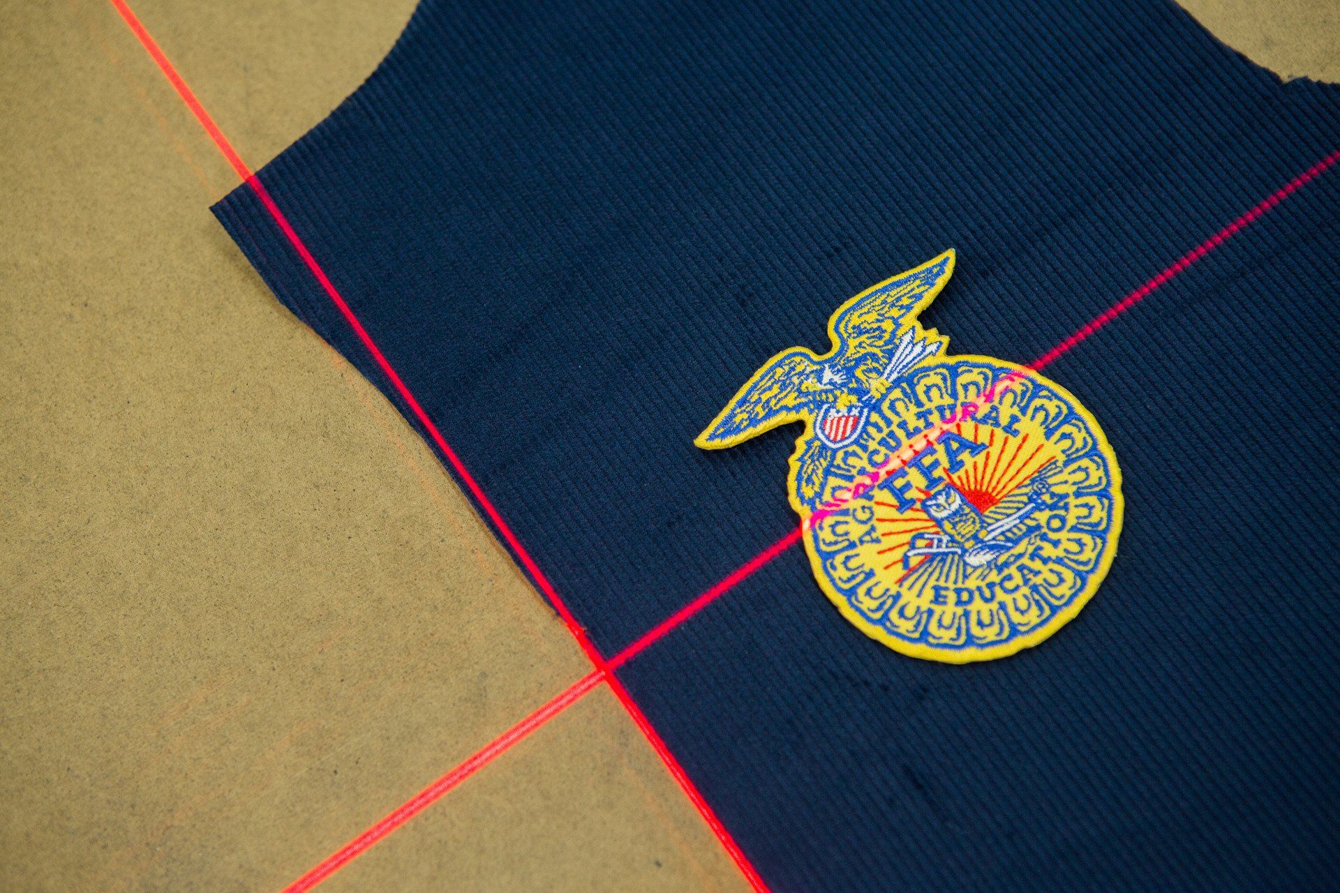 red lasers being used to measure out FFA jackets and patches.