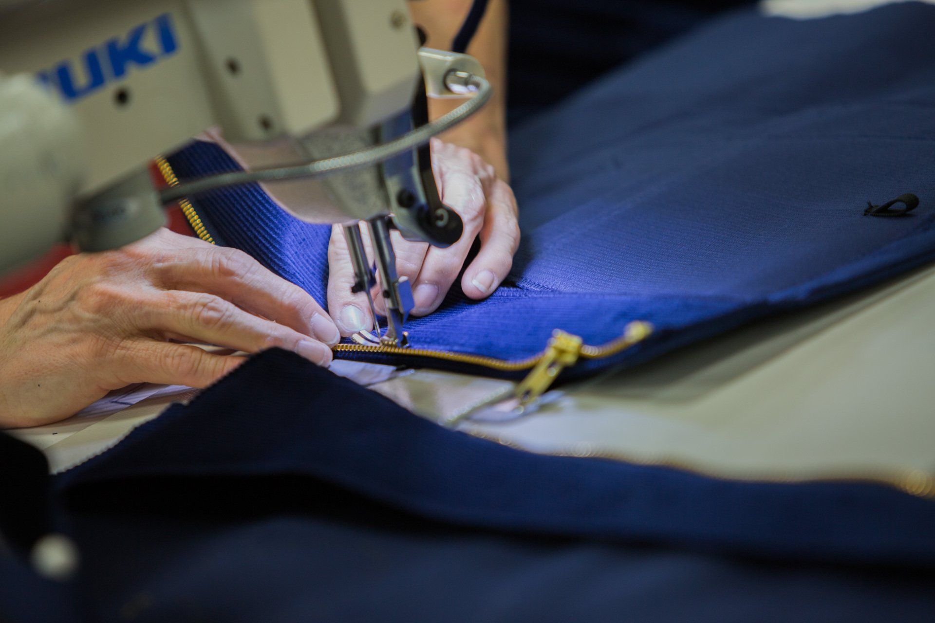 Stitching the zipper on a FFA jacket.