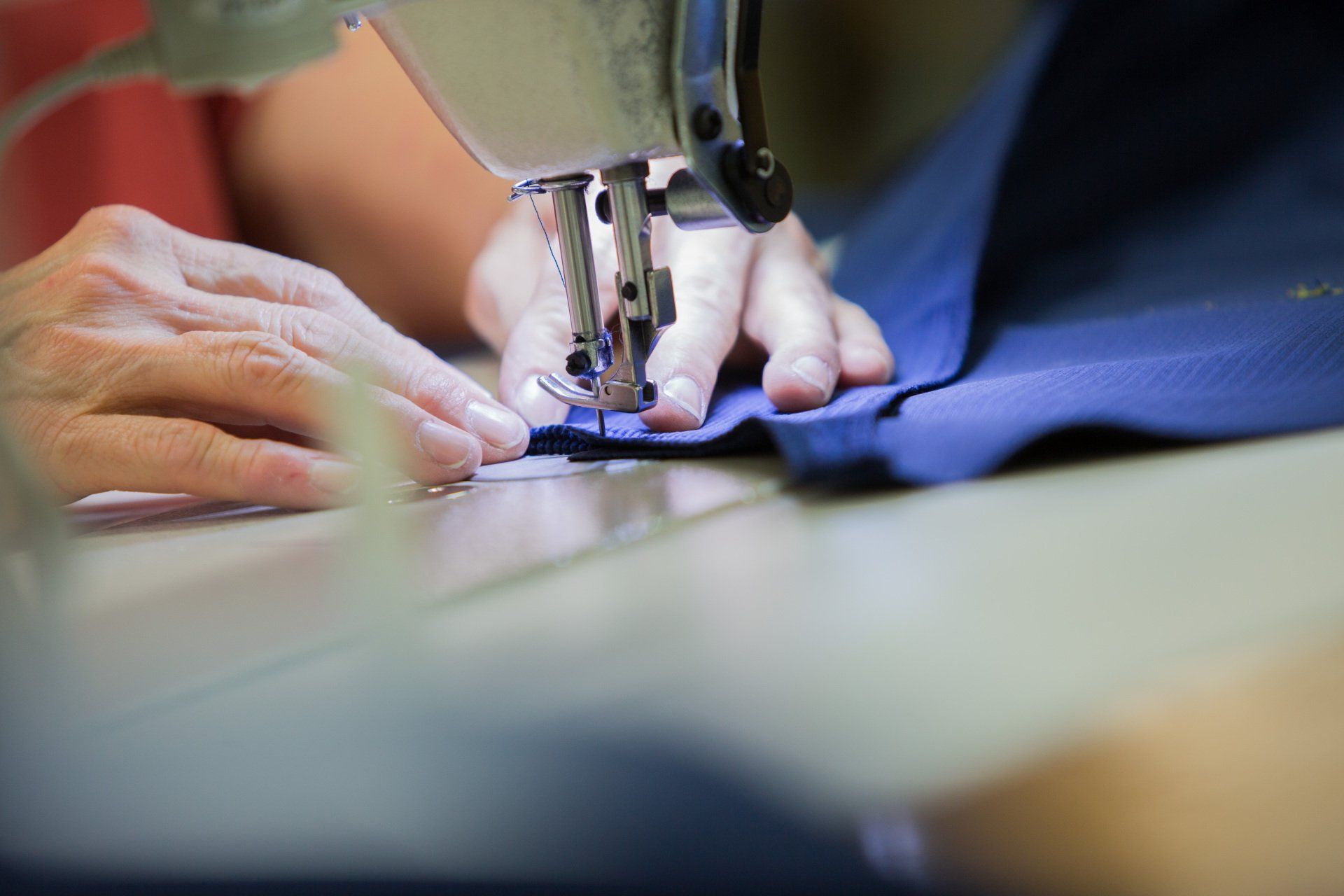 A person sewing together a FFA jacket.