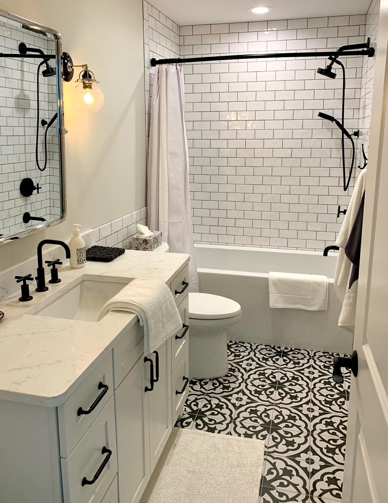 A bathroom with a sink , toilet , bathtub and shower.