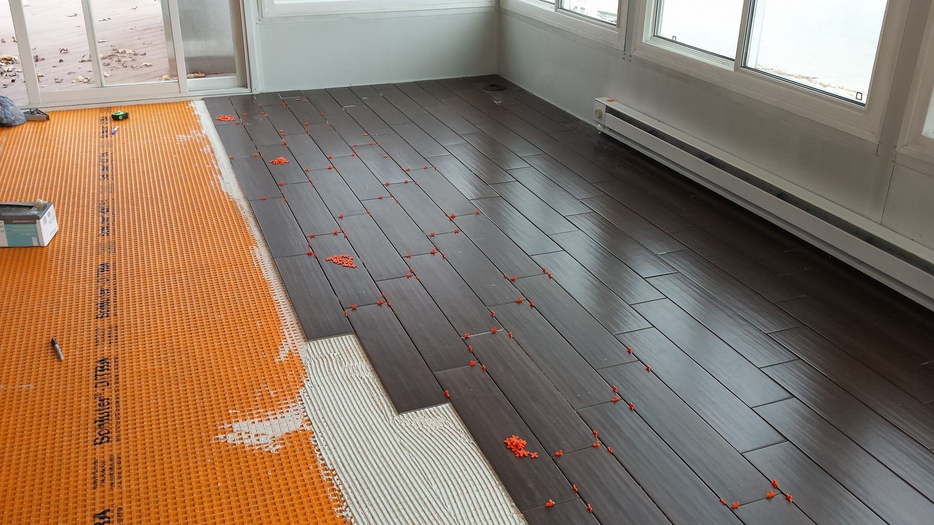 A wooden floor is being installed in a room.