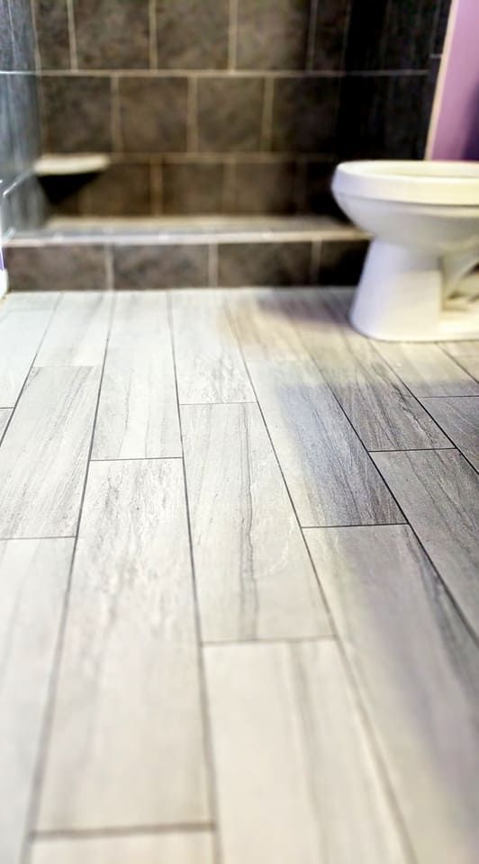 A bathroom with a toilet and a walk in shower.