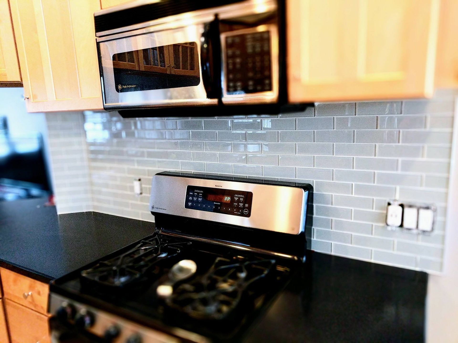 A kitchen with a stove top oven and a microwave.