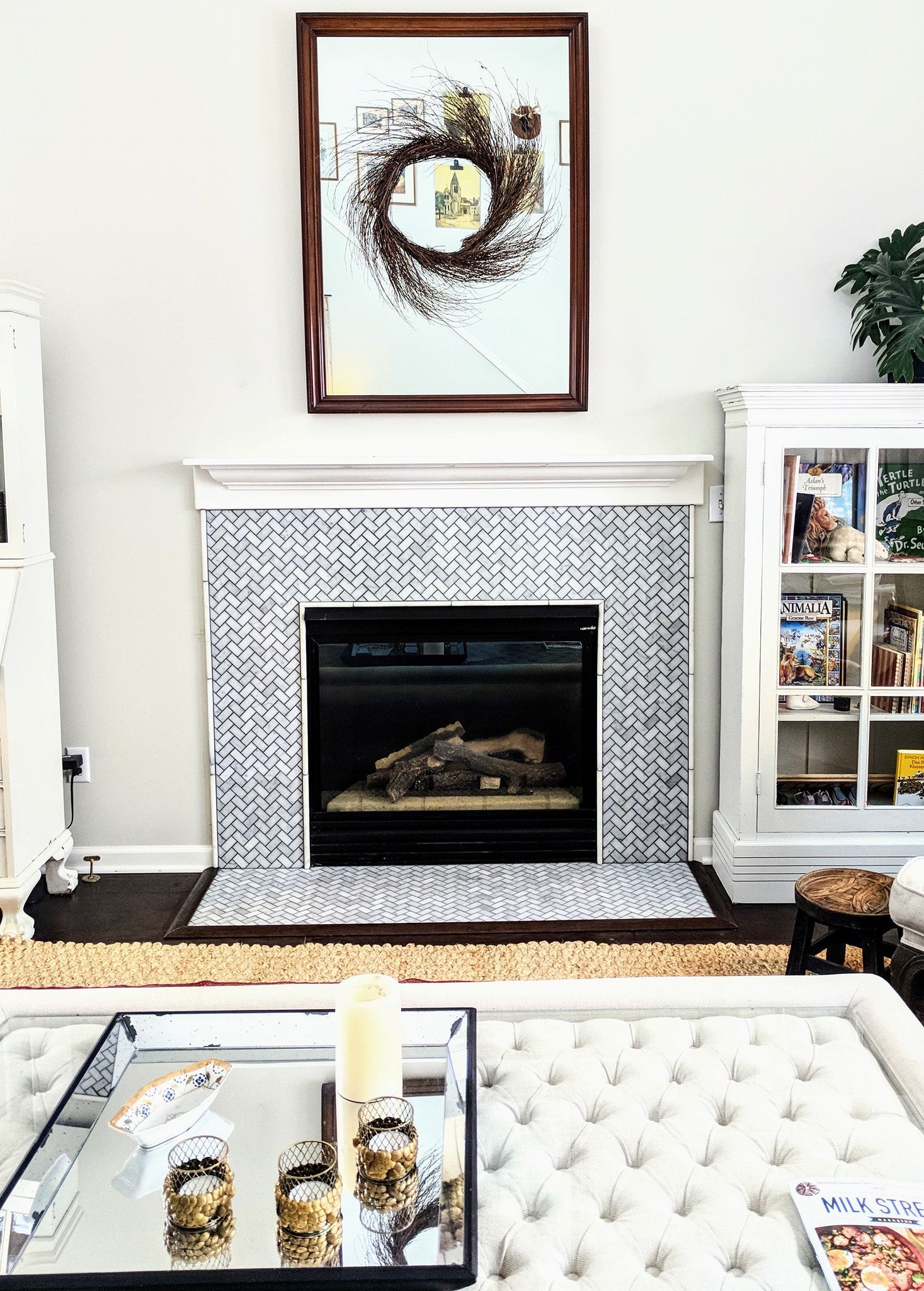 There is a fireplace in the middle of the living room.