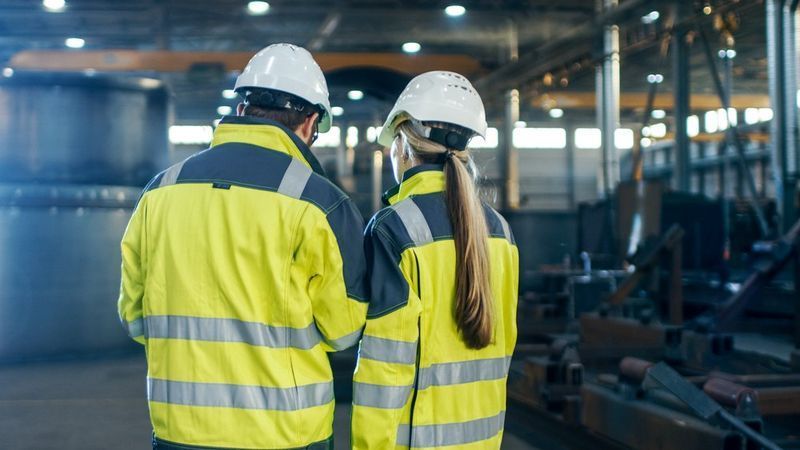 Two People In Safety Vests And Hard Hats In A Factory — Wendy's Safety Services in Moulden, NT
