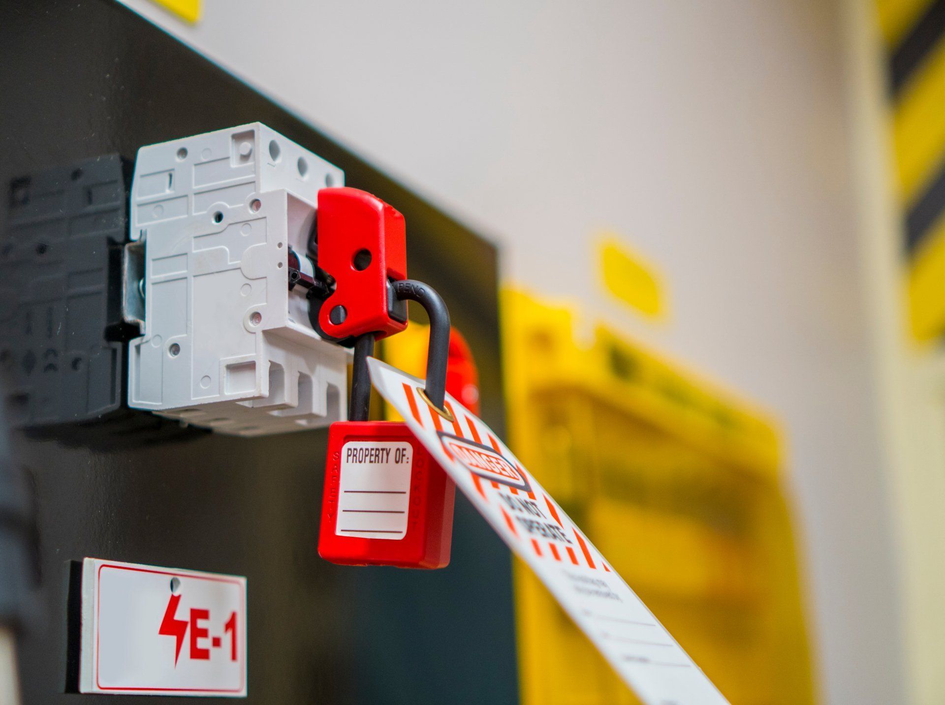 Locked Circuit Breaker With Red Lock And Tag, Likely For Safety And Maintenance — Wendy's Safety Services in Moulden, NT