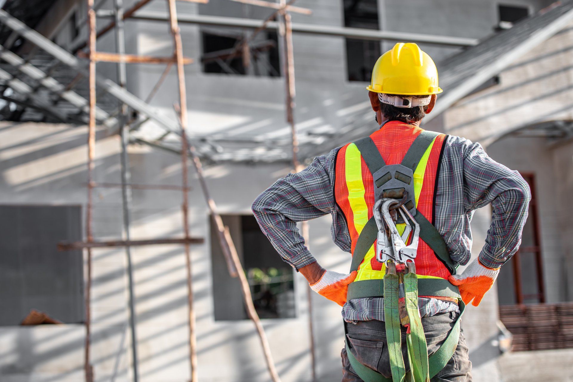 Construction Worker In Safety Harness At A Building Site — Wendy's Safety Services in Moulden, NT