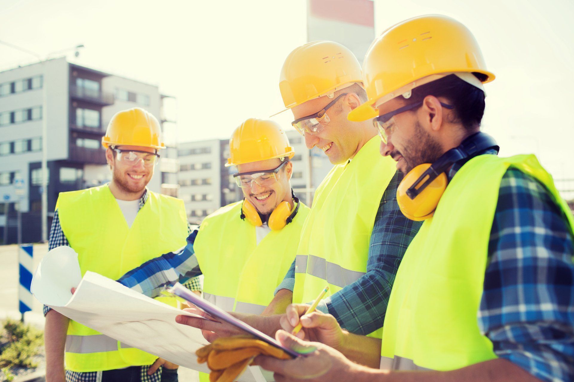 Construction Workers In Hard Hats And Vests Review Blueprints Outdoors — Wendy's Safety Services in Moulden, NT