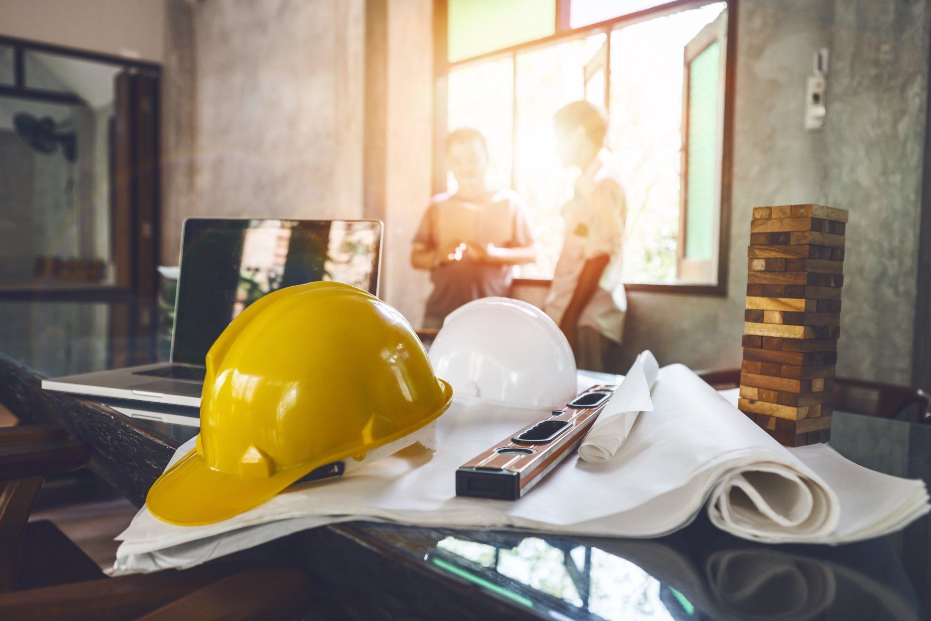 Yellow And White Hard Hats, Blueprints, And Tools On A Table — Wendy's Safety Services in Moulden, NT