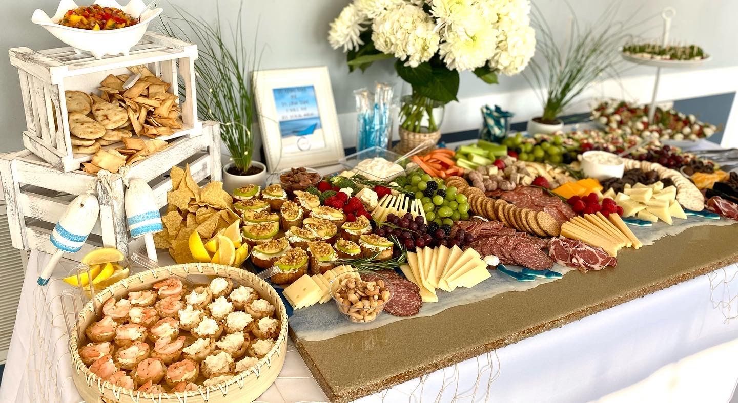A table topped with a variety of food and flowers.