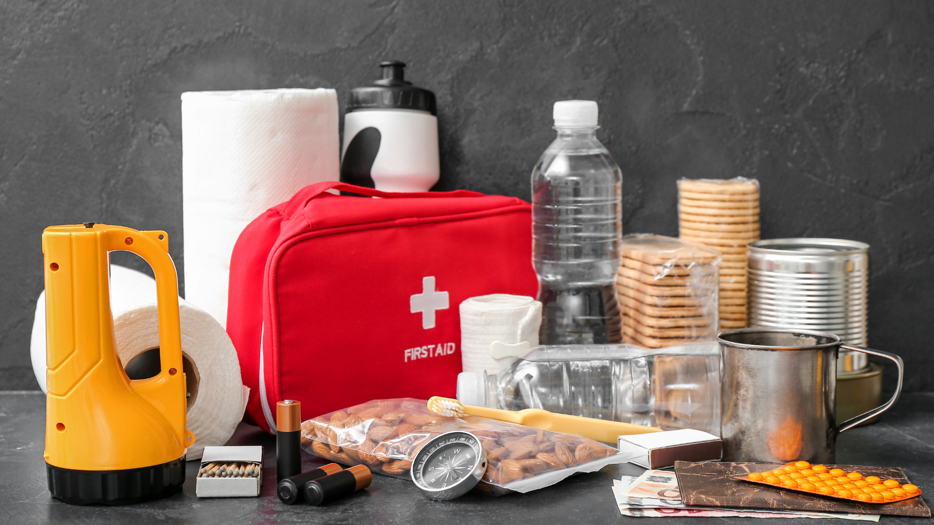 Emergency preparedness kit with water, food, first aid, and flashlight, ready for a crisis.