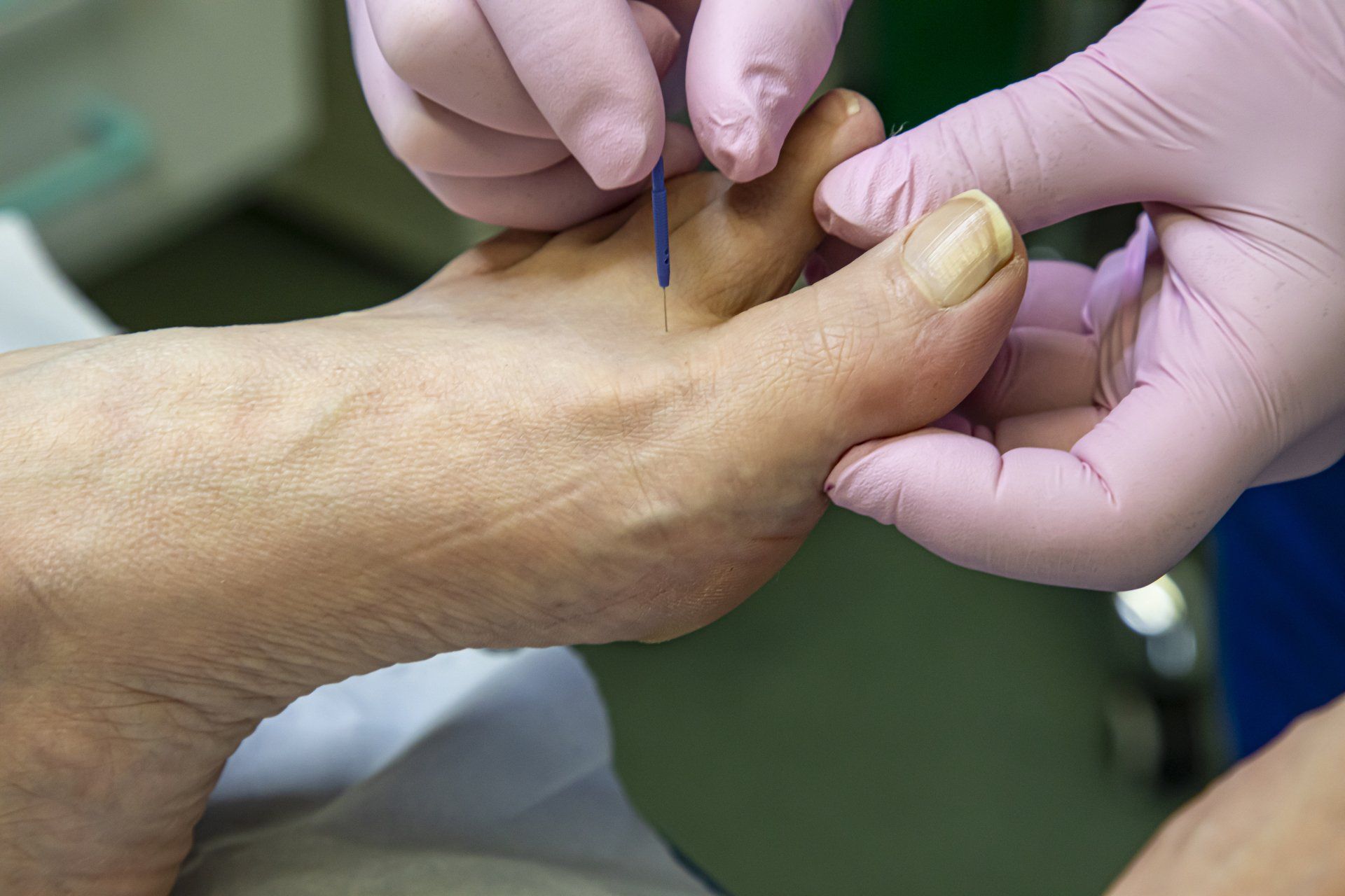 Physiotherapist doing foot massage in medical office