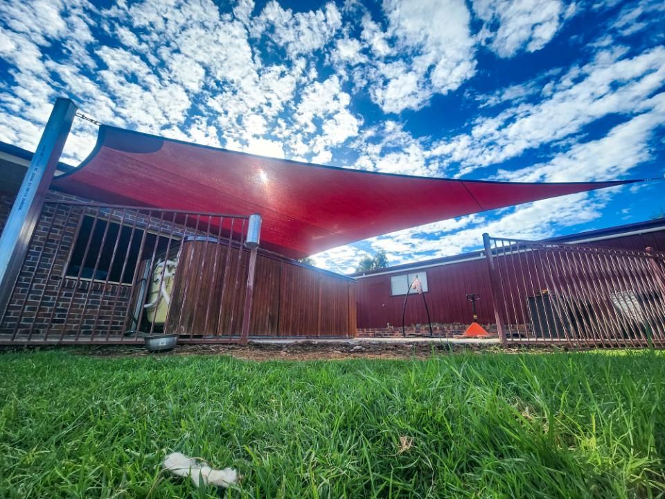 There Is a Red Shade Sail in The Backyard of A House — New England Shade Sails in Armidale, NSW