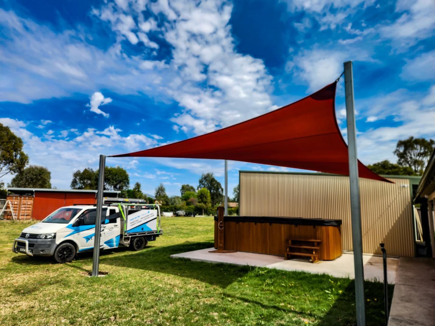 A White Van Is Parked Under a Red Shade — New England Shade Sails in Tamworth, NSW