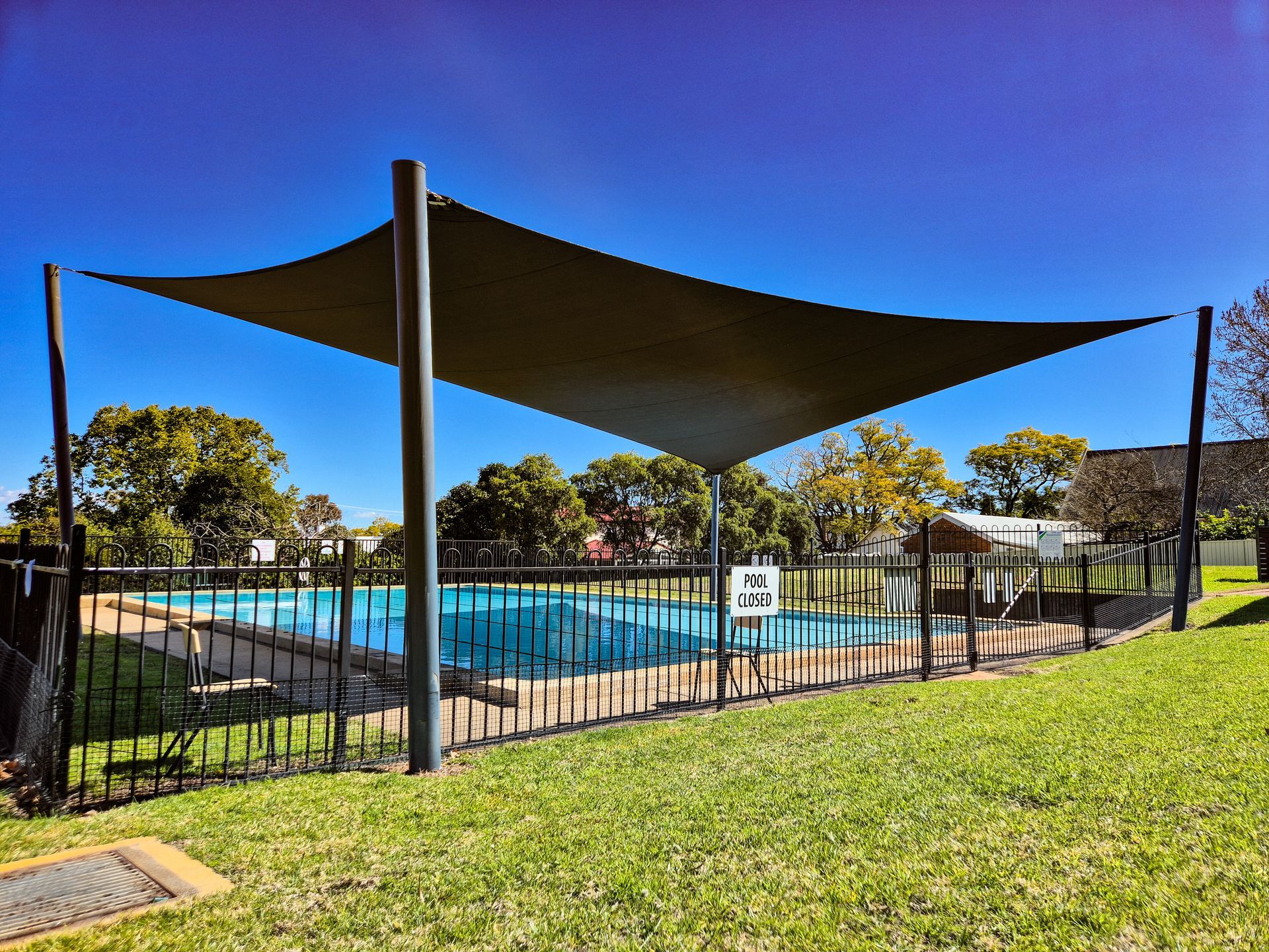 A Large Swimming Pool with A Shade Sail Over It — New England Shade Sails in North Tamworth, NSW
