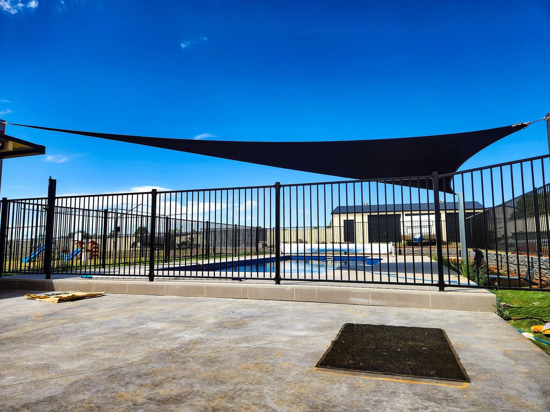 Black Shade Sail Over a Fence - New England Shade Sails in North Tamworth, NSW