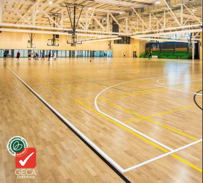 A large indoor basketball court with a geca certification