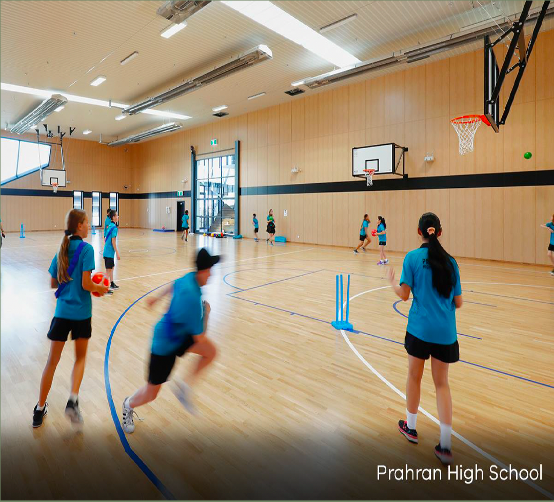 A group of people are playing basketball in a gym at frahran high school