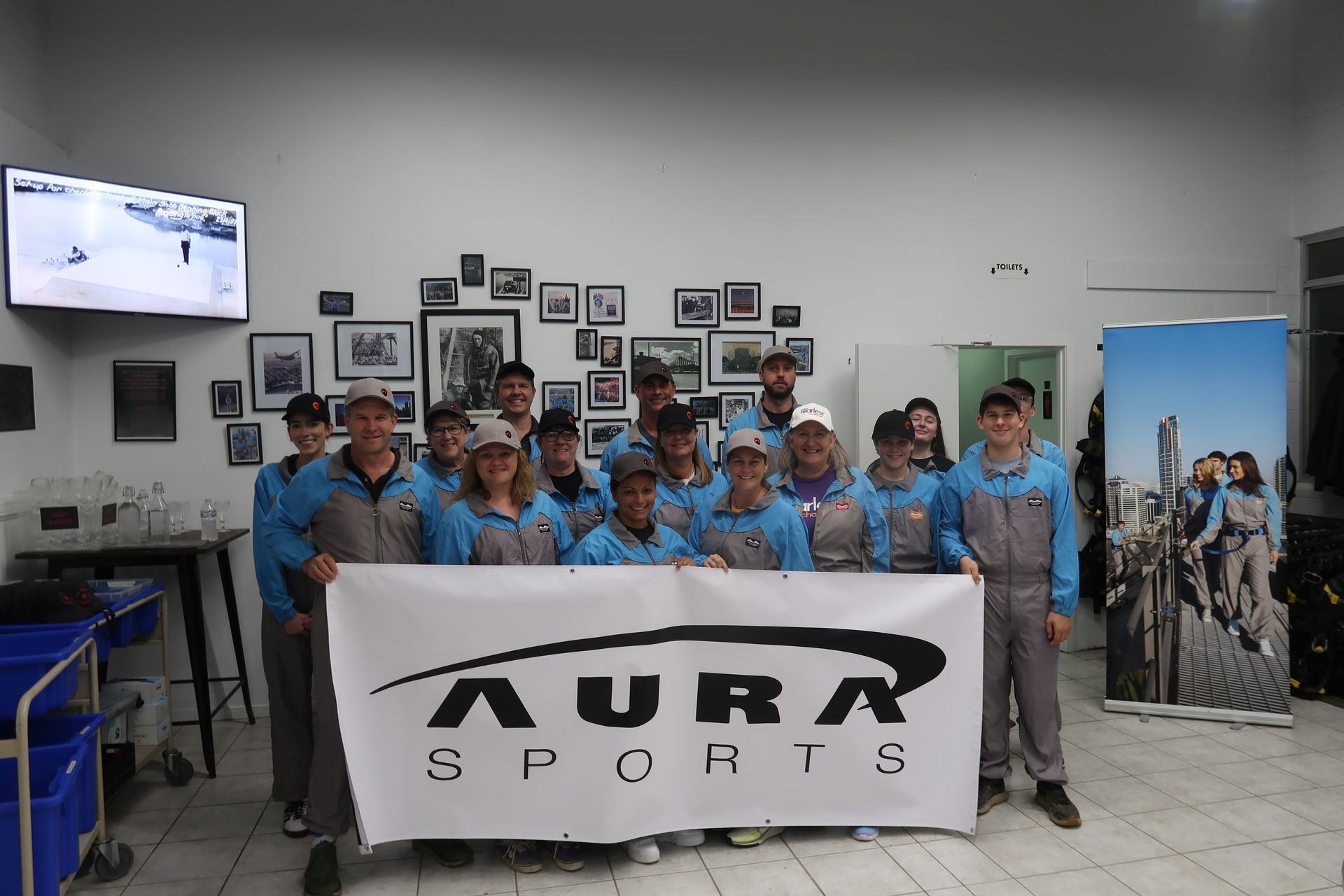 A group of people holding a banner that says aura sports