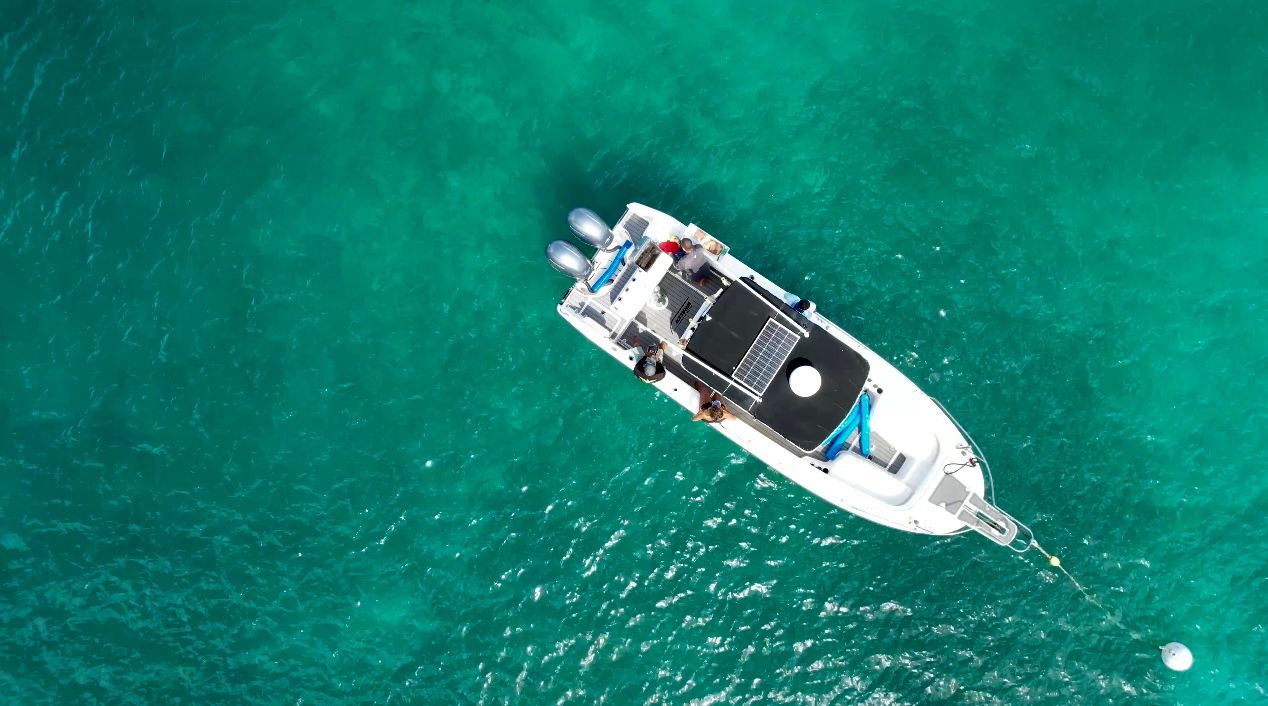 Boat floats on turquoise water.