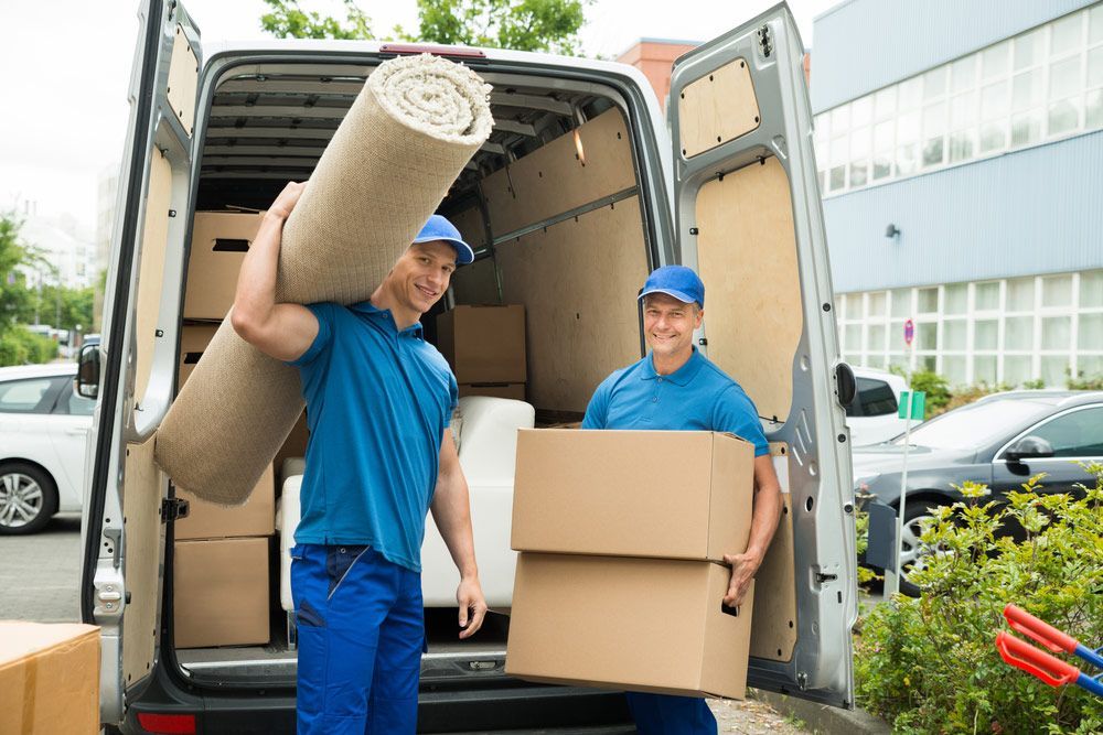 Two Men Are Loading Boxes Into A Moving Van — Crichton Removals In North Geelong, VIC