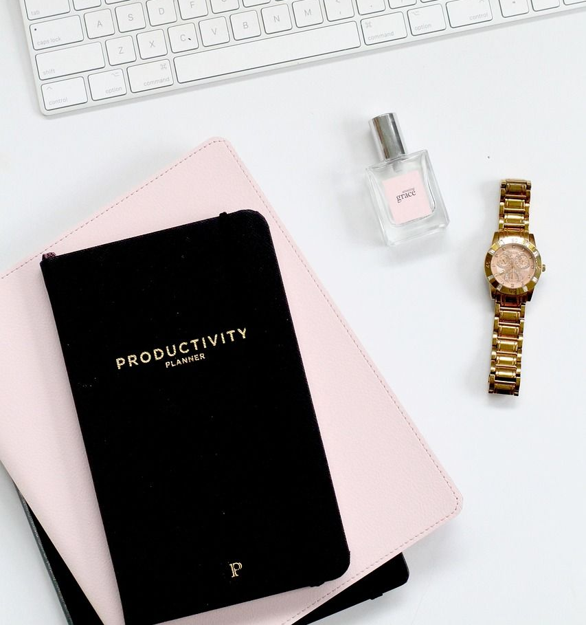 White keyboard, black planner labeled 