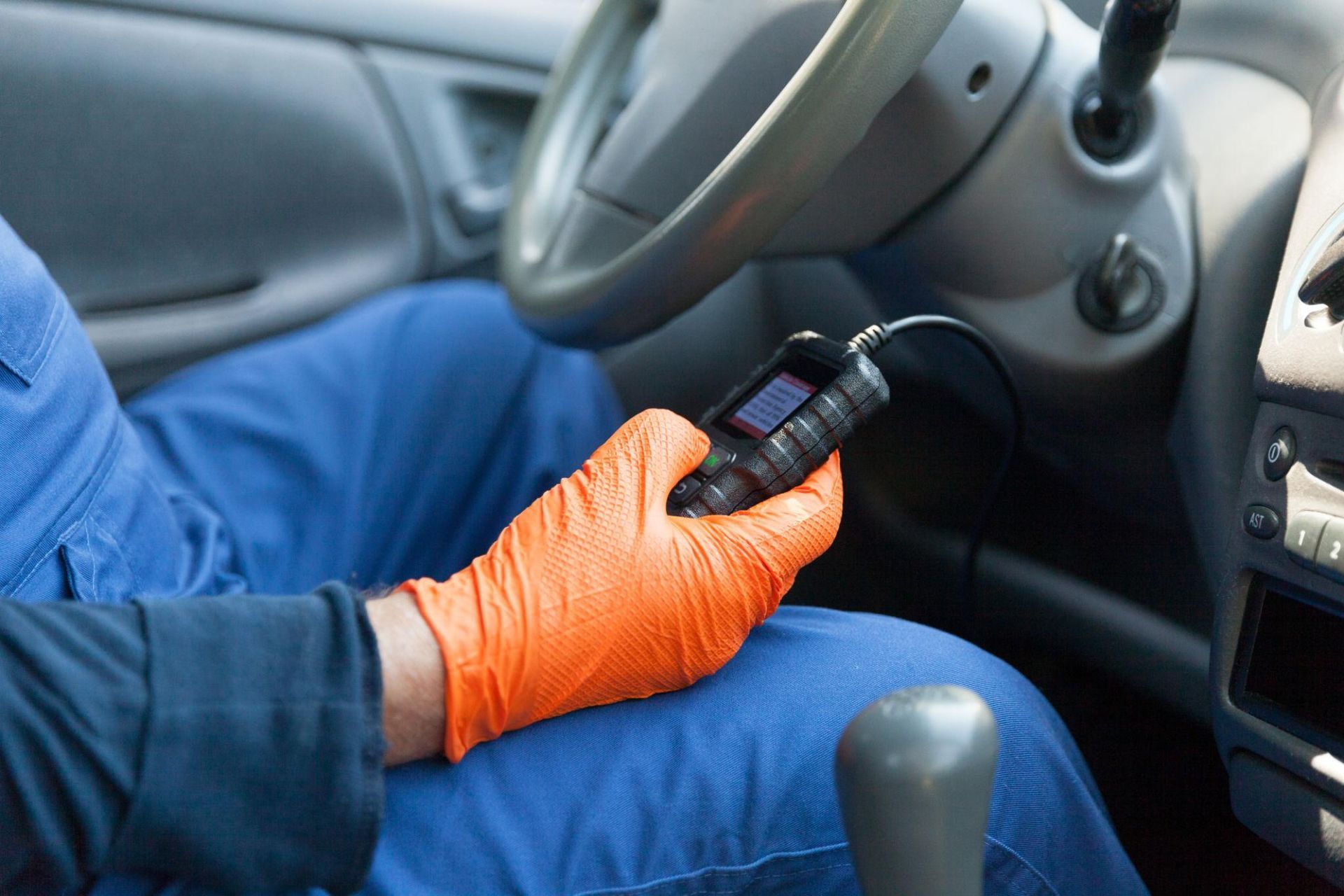 an auto shop mechanic at accountable auto care in broomfield Colorado diagnosing a vehicle with a check engine light on